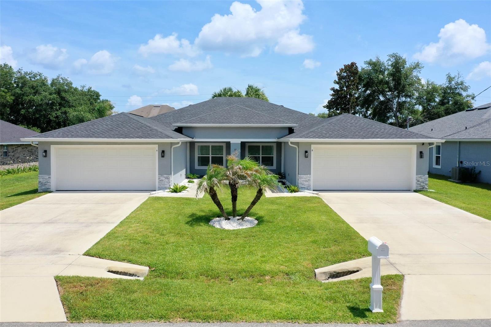 This stunning property is not your typical duplex. You will be completely impressed and in awe the minute you enter this exceptionally well maintained owner-occupied duplex that was custom crafted with premium finishes and meticulous attention to detail. Experience contemporary elegance when you step inside to an open concept layout where the living room, dining area and kitchen flow seamlessly. Each unit offers 1,265 sqft of elegant living space, 2 full bath and a two car garage, providing the perfect blend of modern comfort and functionality. The thoughtfully designed kitchen features amble work space, beautiful quartz countertops, sleek shaker cabinets and exhaust fan, stainless steel appliances, elegant light fixtures, recessed lighting as well as a pantry closet and sliding doors that open onto the lanai to enhance indoor/outdoor living. The primary suite in side B has a cozy fireplace. The master suites have generous walk-in closet, and a well appointed ensuite bathroom with upgraded touches, glass shower doors and tile that extend to the ceiling in both master showers and quest bath tubs. The two additional bedrooms share the second bathroom. The driveway and attached two car garage provide parking and storage options. Additional features: Both units have soaring vaulted ceiling in main living area; stylish and durable luxury ceramic tile plank flooring flows throughout the entire home; the living room modern fireplace elevates the ambiance and creates a welcoming and cozy atmosphere; modern light fixtures and ceiling fans with integrated lighting in all bedrooms, Side B has a kitchen island;  a backyard shed for additional storage; rain gutters, Saint Augustine grass, sprinkle system on well and upgraded landscape. This amazing duplex is nestled in Matanzas Woods within a short distance to highly regarded schools, Advent Health Hospital, shopping, dining, with easy access to I-95 or US-1- 30 minutes North to historic Saint Augustine  and 30 minutes South to Daytona Beach. Seize the opportunity to own this exceptional duplex and schedule your private showing today!