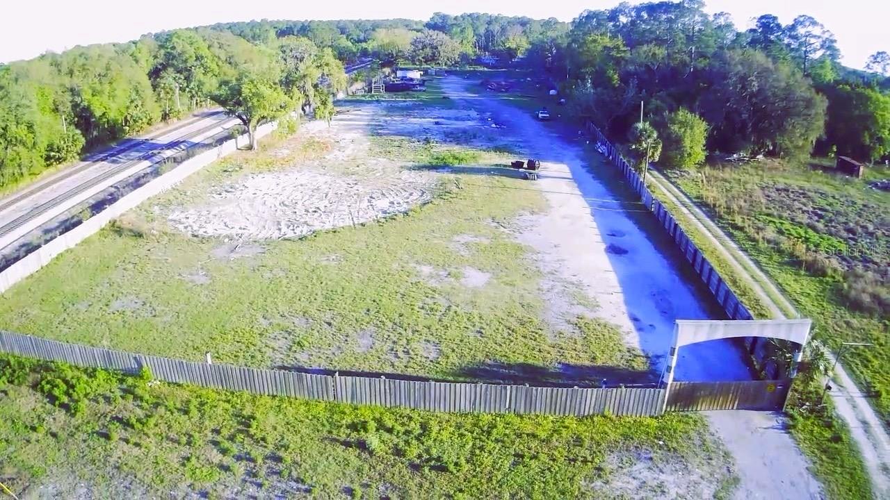 Welcome to a wonderful opportunity — Owner Financing Available, or You Can Buy. Development opportunity (industrial, commercial, or other uses). The property has been completely cleared, is elevated, and remains dry. The seller has removed all structures that previously existed across the various lots; consequently, the buyer may be eligible to receive impact fee credits from Volusia County (DeLand). This property comprises several distinct parcels. The site consists of 4.74 acres—totaling 206,745 square feet—and boasts a superb location within an area currently experiencing significant development, growth, and expansion. The location is perfect for any type of business, situated right next to the Orlando SUNRAIL station in DeLand, Florida. The city that has been voted and acclaimed as a charming, welcoming, and family-friendly small town within the Central Florida region. There is easy access to Stetson University, an institution with a strong focus on athletics that fields teams in football, baseball, basketball, and other sports. If you enjoy nature and the pleasure of crystal-clear river waters, you are just minutes away from De Leon Springs, Blue Spring, and the St. Johns River. The SUNRAIL system connects you to all of Central Florida—including Orlando and Kissimmee—and will soon extend to the Tampa area. This property features access to municipal water and sewer services.