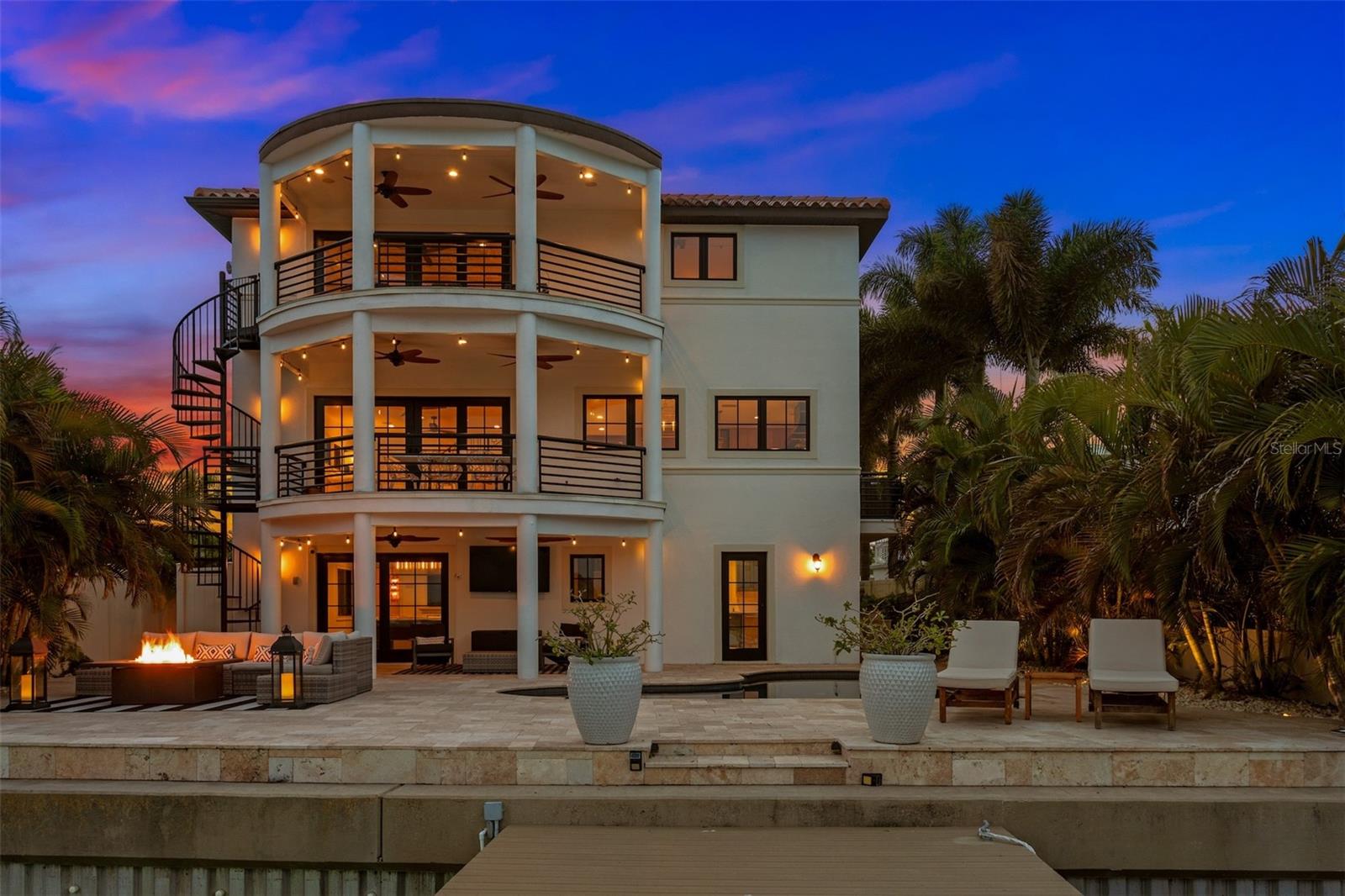 Welcome to your dream waterfront home on Treasure Island! This beautifully built residence has proven its resilience during the recent storms, weathering the storm and performing as expected. The home features a robust construction that has stood the test of time and nature. Main living areas of this elevated home were not impacted by any flooding. 
With its move-in ready status, this home invites you to enjoy a serene living environment without the worry of major renovations. 
This immaculate designer-renovated home is a true masterpiece from head to toe, offering unparalleled luxury and comfort in a prime location. Just a short 0.3-mile stroll to the pristine beaches, this property is a rare gem with a raised seawall on a deepwater canal that presents an exclusive boater's paradise with no fixed bridges.

Step inside this exquisite residence and be captivated by the meticulous attention to detail and high-end finishes throughout, including  Restoration Hardware light fixtures, Jenn Air appliances, custom sourced 100+ year old beams, rare Dalmata stone on various spaces, impact windows and much more. The open-concept living spaces are full of natural light, showcasing breathtaking views straight down the canal and creating an inviting ambiance. The gourmet kitchen is a chef's delight, featuring Jenn Air and Viking appliances, custom cabinetry, a hidden pantry area, a custom wine bar, and a center island covered in extremely rare Dalmata stone. A double sided gas fireplace with custom cast concrete mantles and a marble floor apron connects the space of the living room to the kitchen.

The master suite is a tranquil retreat with panoramic water views, a private deck, a gas fireplace, a spa-like ensuite bathroom, and ample closet space. Additional bedrooms and bathrooms are equally well-appointed, ensuring comfort for family and guests alike. Every room has been thoughtfully designed to provide a harmonious blend of luxury and functionality.

Step outside to the expansive waterfront deck, where you can indulge in outdoor living at its finest. The raised seawall ensures privacy and security, while the deepwater canal offers direct access to the open waters, making it perfect for boating enthusiasts. Imagine entertaining guests on your private patio while enjoying the serene water views or launching your boat for a sunset cruise without the hassle of fixed bridges.

This Treasure Island gem is not just a home; it's a lifestyle. With the beach as well as numerous restaurants just a short walk away and the convenience of waterfront living, you'll relish the tranquility and beauty of your surroundings. Don't miss the opportunity to own this impeccable home in one of the most sought-after locations. Inquire for a list of all upgrades and to schedule a private showing!