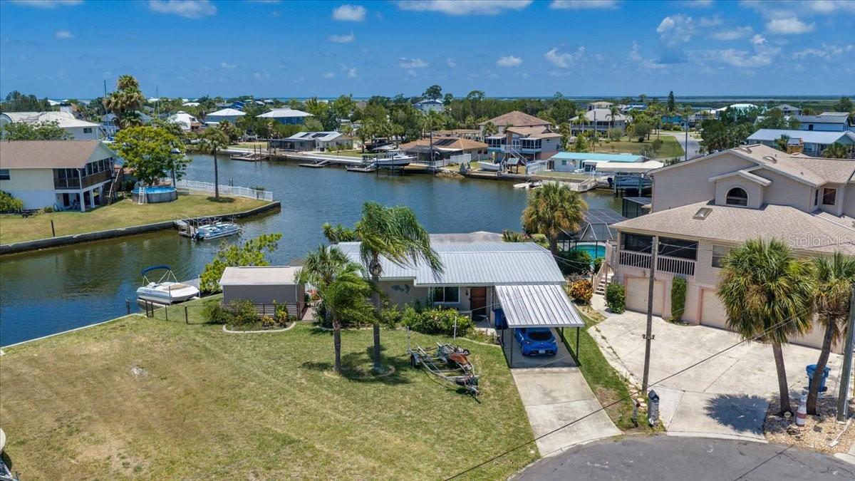 Under contract-accepting backup offers. INVESTOR SPECIAL!! WATERFRONT OPPORTUNITY WITH DIRECT GULF ACCESS! Bring your vision and unlock the incredible potential of this 3 BEDROOM, 2 BATHROOM BLOCK CONSTRUCTION home ideally situated on a quiet CUL-DE-SAC at the end of a canal in desirable HERNANDO BEACH. Boasting approximately 120 FEET OF CONCRETE SEAWALL and DIRECT GULF ACCESS, this property is a boater's dream and offers endless possibilities for a primary residence, vacation getaway, investment property, or short-term rental opportunity.
Enjoy beautiful water views from the spacious living room featuring a large picture window overlooking the canal. The home offers durable TERRAZZO FLOORING in the main living area and inside the laundry room,. Major improvements include NEW WINDOWS INSTALLED IN 2022 and a METAL ROOF REPLACED IN 2019, providing peace of mind for years to come.
The owner of the home did many upgrades to the property post Hurricane Helene including a new  UPDATED GRAY KITCHEN CABINETS, GRANITE COUNTERTOPS, and white appliances as well as repairing the master bedroom and master bathroom. The home still has lots of improvements that are needed including drywall, trim, electric updates, etc.
Step outside and enjoy the Florida waterfront lifestyle with an OPEN DECK, FLOATING DOCK, SCREENED LANAI, CARPORT, storage shed, and a spacious backyard with PLENTY OF ROOM FOR A POOL. Whether you're fishing from your backyard, launching your boat for a day on the Gulf, or simply relaxing while taking in the waterfront views, this property offers the perfect coastal setting.
Located in the highly sought-after Hernando Beach community, residents enjoy DIRECT GULF ACCESS boating, world-class fishing, kayaking, paddleboarding, waterfront dining, and breathtaking sunsets. The area is GOLF CART FRIENDLY and offers convenient access to the famous WEEKI WACHEE SPRINGS, the WEEKI WACHEE RIVER, local marinas, waterfront restaurants, shopping, and entertainment. With NO SHORTAGE OF OUTDOOR RECREATIONAL ACTIVITIES and easy access to the SUNCOAST PARKWAY for commuting to Tampa, this coastal community truly allows you to LIVE EVERY DAY LIKE YOU'RE ON VACATION.
With solid bones, exceptional waterfront features, and an unbeatable location, this property is ready for its next owner to add the finishing touches and make it shine once again. Don't miss this rare opportunity to own an affordable DIRECT GULF ACCESS waterfront home in Hernando Beach!