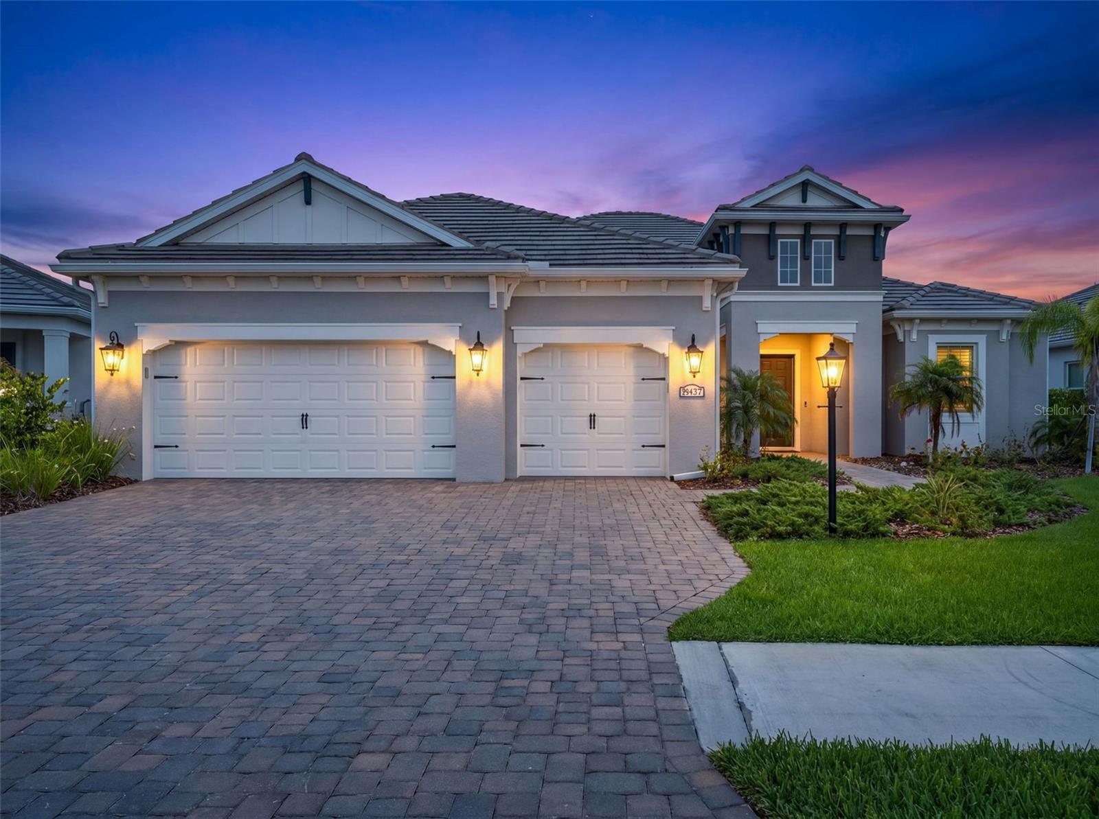 Virtually Staged. WELCOME TO GRAND PALM LIVING AT ITS FINEST! Built by Neal Communities, this highly upgraded CAPTIVA model offers nearly 2,700 square feet of thoughtfully designed living space with 3 BEDROOMS, 3 FULL BATHS, a DEN/OFFICE, MEDIA ROOM/FLEX SPACE, and a 3-CAR GARAGE in one of Venice’s most amenity-rich and sought-after communities. Situated on a beautifully landscaped homesite with peaceful GREENBELT and TREES/WOODS views, this home blends luxury finishes, functional design, and the ultimate Florida lifestyle.

From the moment you arrive, the BRITISH WEST INDIES elevation, upgraded paver driveway, coach lights, tile roof, and oversized covered lanai create stunning curb appeal. Inside, the OPEN FLOOR PLAN features soaring ceilings, COFFERED CEILINGS, 8-FOOT INTERIOR DOORS, recessed lighting, upgraded wood-look tile flooring throughout, and expansive 90-DEGREE CORNER SLIDING GLASS DOORS that completely open the home to the outdoor living space.

The chef’s kitchen was extensively customized with LEVEL 3 LINEN CABINETRY with 42” uppers, SOFT-CLOSE cabinetry, roll-out shelving, pot and pan drawers, pull-out trash storage, CALACATTA NOVELLO QUARTZ countertops, an oversized island with decorative panels, designer cabinet hardware, under-cabinet LED lighting, a Kohler Whitehaven apron-front farmhouse sink, brushed gold Moen Align faucet, GE Profile stainless appliances including gas cooktop, wall oven/microwave combo, French door refrigerator, upgraded dishwasher, and a full-height designer backsplash extending to the cabinet crown molding.

The spacious primary suite offers a luxurious retreat with upgraded walk-in shower, dual vanities, quartz countertops, linen cabinetry, oversized walk-in closet, recessed lighting, and spa-inspired finishes throughout. Secondary bedrooms provide privacy for guests while the den and media/flex room offer incredible versatility for working from home, fitness space, hobbies, or additional entertaining areas.

Designed for true indoor-outdoor Florida living, the EXTENDED COVERED LANAI includes outdoor kitchen rough-in, gas stub-out, refrigerator circuit, pool pre-wire package, and expansive entertaining space ready for your dream backyard oasis.

Grand Palm residents enjoy resort-style amenities that make everyday life feel like a vacation, including multiple resort pools, a FITNESS POOL for laps and water aerobics, miles of walking and biking trails with bike racks, pickleball, tennis, bocce ball, volleyball and basketball courts, dog parks, splash park, playgrounds, social clubs, fitness center, and scenic Lookout Point Island with breathtaking nature views. Located near Wellen Park, Downtown Venice, Gulf beaches, dining, shopping, Braves spring training, and I-75, this home offers the perfect balance of luxury, lifestyle, and location.

WHY WAIT TO BUILD when you can own a BETTER-THAN-NEW professionally upgraded home loaded with designer selections and high-end finishes in one of Venice’s premier resort-style communities?