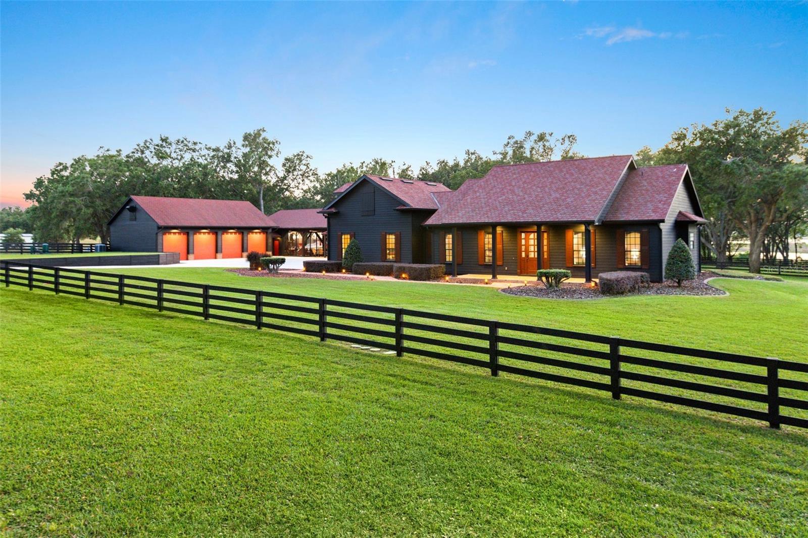 Encompassing five pristine acres, this exceptional compound offers a rare blend of privacy, craftsmanship, and refined outdoor living. Framed by mature oaks and approached by a picturesque, tree-lined drive, the property unfolds as a secluded retreat designed for casual entertaining and boundless enjoyment of serious hobbies and collections.  

At the heart is a 3,041-square-foot farmhouse rich in warmth and architectural character, offering 3 bedrooms, 2.5 bathrooms, a flex room, and a second-floor bonus space. Thoughtfully designed for function and lifestyle, the estate is further enhanced by a detached lakeside retreat—featuring a 4-car garage with 13-foot doors, multiple vehicle lifts, epoxy floors, and an integrated compressor system. An air- conditioned 2nd story storage area is accessed by elevator.  The commercial kitchen, comfortable gathering area, and private lounge create a truly unique environment for entertaining and displaying prized possessions.

Additional features include a 6-car pavilion and BBQ pergola with a stone fire pit.  Structures are versatile - offering endless possibilities for collectors, creatives, or future expansion. The sweeping setting captures serene lake and sunset views, while a whole-property generator and security system provide comfort and peace of mind.

With ample room to expand, the existing residence can serve as a guest home while a new primary estate is brought to life. Zoned for horses and ideally located just minutes from Hamlin Town Center, with convenient access to SR-429, Walt Disney World, and downtown Winter Garden, this is a rare opportunity to create a true legacy compound.  All TV's included.  Furnishings and other items may be available to purchase.  See attachments for Feature Sheet.