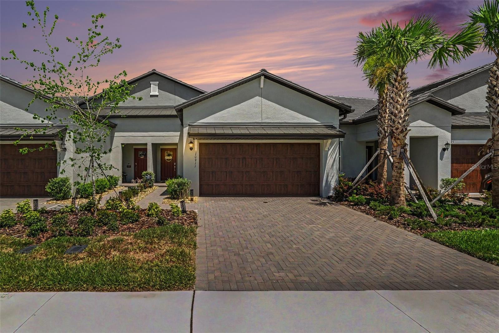 Welcome to this stunning Aurora II villa in the highly sought-after Angeline community of Land O' Lakes! Offering 1,747 square feet of thoughtfully designed living space, this two-story home features 2 bedrooms, 2.5 bathrooms, a versatile flex room, and a spacious 2-bay garage. Enjoy Florida living at its finest from the screened-in lanai with beautiful epoxy flooring and tranquil pond views. Best of all, this home is within walking distance of the community's Contemporary-style clubhouse, featuring a resort-style pool, pickleball courts, bocce ball, shuffleboard, and a full calendar of social events and activities.

Inside, you'll find numerous upgrades throughout. Custom closet systems have been installed in both primary bedroom closets, the pantry, entry closet, and laundry room, providing exceptional organization and storage. Luxury vinyl flooring enhances the staircase and both bedrooms, creating a seamless and elegant look. The garage also features durable epoxy flooring for a clean, polished finish.

The open-concept floor plan is perfect for everyday living and entertaining. The kitchen is accented by a stylish backsplash and flows effortlessly into the dining and living areas. Custom paint details add warmth and character to the living room, creating an inviting atmosphere.

As an added bonus, the bedroom furniture and dining room furniture may be included with an acceptable offer, making this an exceptional opportunity for buyers seeking a truly move-in-ready home.

This beautifully maintained villa combines thoughtful upgrades, low-maintenance living, peaceful water views, and an unbeatable lifestyle in one of Pasco County's most exciting master-planned communities. Whether you're looking to stay active, socialize with neighbors, or simply relax and enjoy the view, this exceptional home offers it all.
