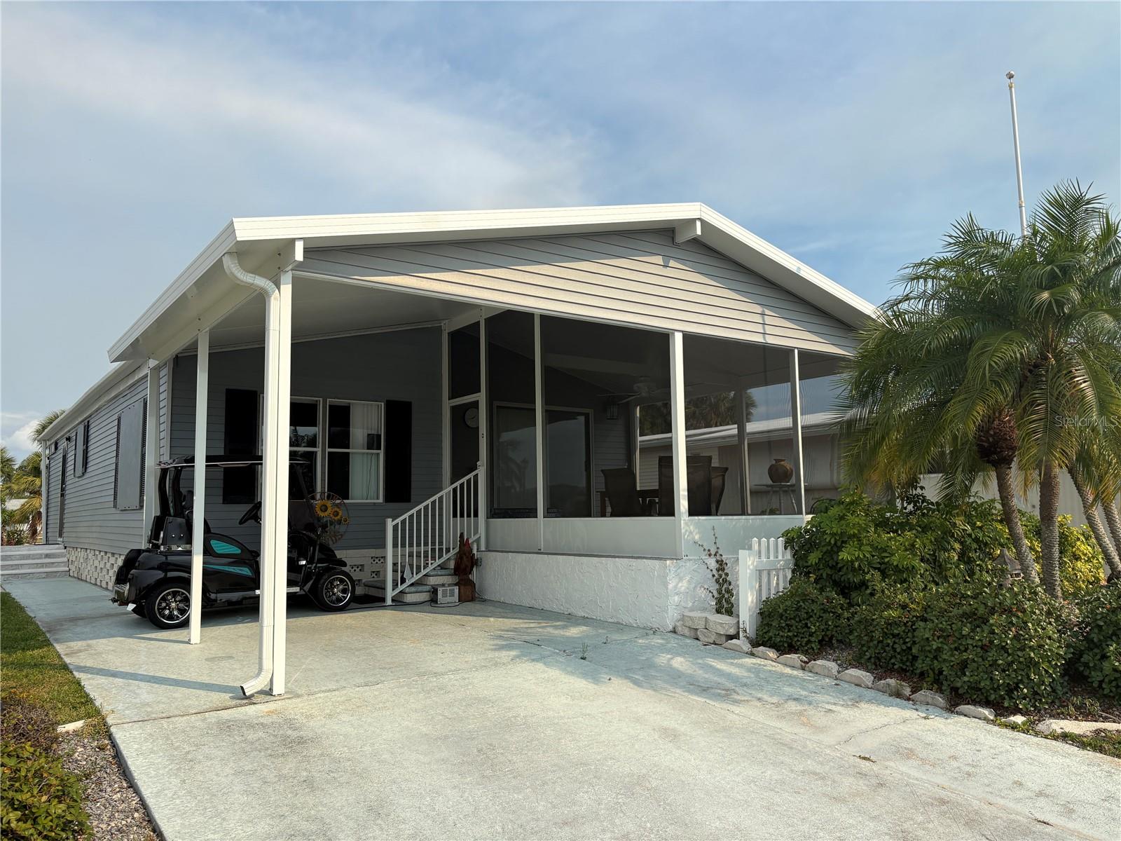 Move-in ready and sold furnished, this charming 2-bedroom, 2-bathroom mobile home is located in the friendly 55+ community of Holiday Park and offers the perfect blend of comfort, convenience, and outdoor living. Looking for a home with plenty of outdoor space? This is it! A large, inviting lanai welcomes you from the moment you arrive, creating the perfect place to relax with a morning coffee, enjoy the Florida breeze, or entertain friends in style. The attractive curb appeal and spacious outdoor setting make a lasting first impression. Step inside to discover a bright and open living and dining area designed for easy everyday living. Natural light fills the space, creating a warm and cheerful atmosphere throughout the home. The beautifully updated kitchen is a standout feature, offering 36-inch wood cabinets with elegant crown molding, modern lighting, stainless steel appliances, and plenty of storage and workspace. There is also ample room for an eat-in dining nook, making it easy to enjoy casual meals in comfort. For added convenience, the washer and dryer are located indoors. The spacious primary bedroom includes a ceiling fan and a walk-in closet, while the ensuite bathroom features wood cabinetry, a cultured marble countertop, a Roman shower, and glass doors. This well-maintained home combines thoughtful updates with practical features, making everyday living easy and enjoyable. New waterproof laminate flooring will be installed in just a few days! Beyond the home itself, Holiday Park offers an active and engaging lifestyle with an impressive selection of amenities. Residents enjoy access to two community pools, pickleball courts, shuffleboard, bocce courts, horseshoe pits, a dart room, and ping pong. The fitness center provides a great place to stay active while taking advantage of the many social and recreational opportunities available throughout the community. Conveniently located within walking distance of local restaurants and shopping, this property also places you just 25 minutes from the beautiful shores of Manasota Beach and Venice Beach, where spectacular Gulf of Mexico sunsets create unforgettable evenings. In Holiday Park, you own the land with a deed, adding exceptional value and peace of mind. The annual association fee of $2,340 ($195./month) is conveniently included in your yearly real estate taxes. Don’t miss this incredible opportunity to enjoy comfortable living in a thriving community with outstanding amenities and expansive outdoor space—schedule your private showing today!