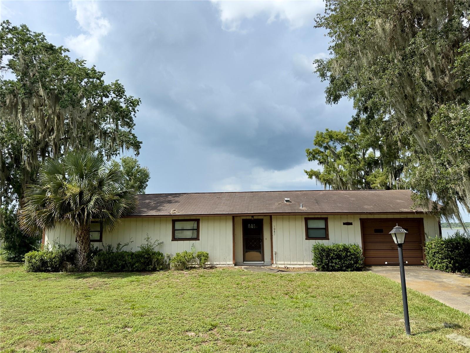 Fixer-upper. Waterfront property in the Tracy’s Point area in Lake Panasoffkee. 2 bedroom. 2 bathroom. 1 car garage. 1386 sq.ft. Built in 1983. On .30 acre. Septic tank. Public water. Cash only. Property is being sold As-Is. This home has experienced some settling and is priced accordingly. A recent geologist report summarizing the results and conveying their professional opinion is on file and available upon request. Lake Panasoffkee is known for boating, fishing, and outdoor recreation. This property could work well as a full-time residence, seasonal home, or weekend getaway. Located approximately 10 minutes from interstate 75 and the Florida Turnpike, 15 minutes to Bushnell, 20 minutes to the Villages, 45 minutes to Ocala, and about an hour to Tampa and Orlando. Very easy to show, but by appointment only. Call today.