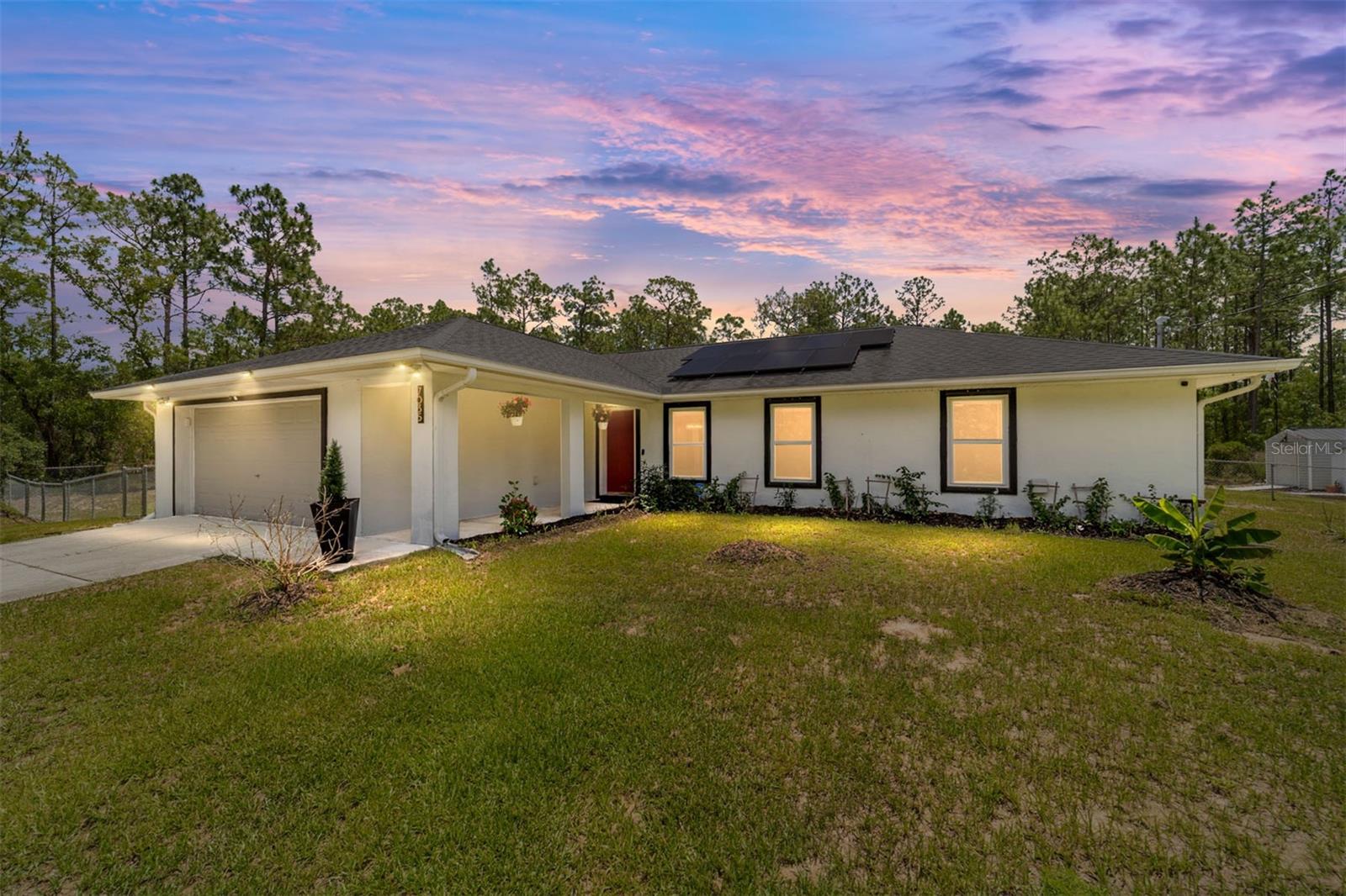 BEAUTIFUL HOME WITH ENDLESS UPGRADES ON 1.16 ACRES IN ROLLING HILLS. This home features 4 bedrooms, 2 bathrooms, with an open split floorplan and new laminate floors in every room. Freshly painted, inside find granite counter tops, new kitchen appliances (2024), Waterdrop whole house water filtration system, new AC (2024) with UV Air Quality Upgrade still under warranty, Astomi Motorized Smart Blinds, LG TurboSteam High Efficiency Washer/Dryer (2023). Outdoor area features a lovely covered and lit lanai with spa, fish pond, deck and huge pool. The property has been landscaped with banana, citrus and guava fruit trees, as well as, raised beds. TRULY STORM READY with GERERAC 500 gallon propane generator, solar panels, custom metal hurricane shutters (lightweight and can be installed easily and quickly), newer roof (2021) and hurricane windows, you are ready for anything. There are 2 outdoor sheds, as well as an oversized 2 car garage with additional fridge. The house is equipped with 10 Blink HD security cameras and video doorbell. With no HOA, large lot sizes, proximity to WEC, Rolling Hills is one of the most sought-after areas of Ocala. Owner will payoff solar panels at closing. Come see why this is property offers value, privacy, and security surrounded by nature.
