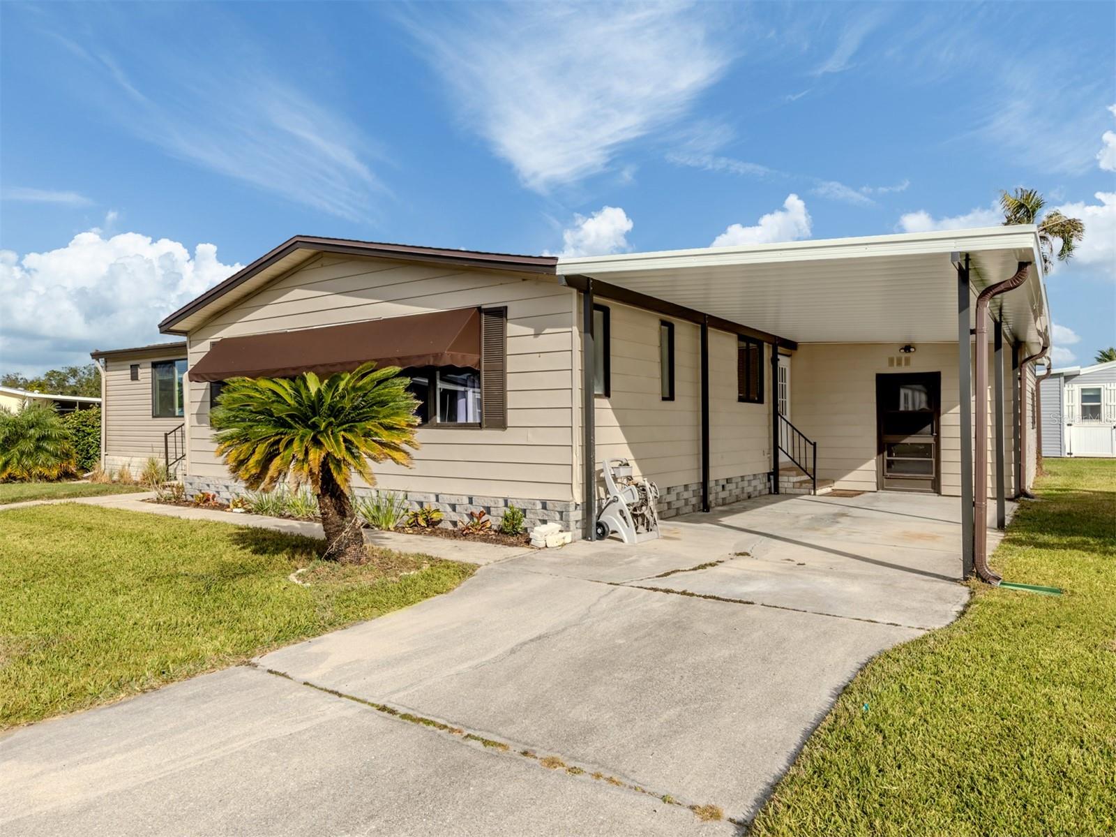 Discover spacious coastal living in this beautifully updated 1,592 sq ft home situated on a desirable corner lot in the pet-friendly, land-owned community of Harbor Isles. One of the standout features of this property is the impressive 25 x 20 Florida room, complete with new windows and a mini-split system, offering the perfect space for a pool table, hobby area, or an expansive entertainment retreat.
Inside, the home shines with character and thoughtful updates. The kitchen features stunning refinished butcher block counters paired with striking navy-blue cabinets with convenient pull-outs. New luxury vinyl flooring flows throughout the main living areas, while both bedrooms offer the comfort of new carpeting. Vaulted ceilings add an airy feel, and the master suite boasts a large walk-in closet along with vessel sinks in both bathrooms for a modern touch.
Additional upgrades include a new electrical panel with whole-house GFCI protection, a 2022 roof, a 2023 carport, inside laundry, and an extra-large storage shed providing plenty of room for tools, bikes, or beach gear.
Harbor Isles is a highly sought-after land-owned community offering resort-style amenities, including a heated pool and spa, a well-equipped fitness center, tennis and pickleball courts, shuffleboard, a clubhouse with year-round activities, and a marina with access to the Myakka River. With its vibrant social atmosphere, beautiful landscaping, and convenient location near shopping, dining, and Gulf Coast beaches, Harbor Isles is the perfect place to enjoy the Florida lifestyle.