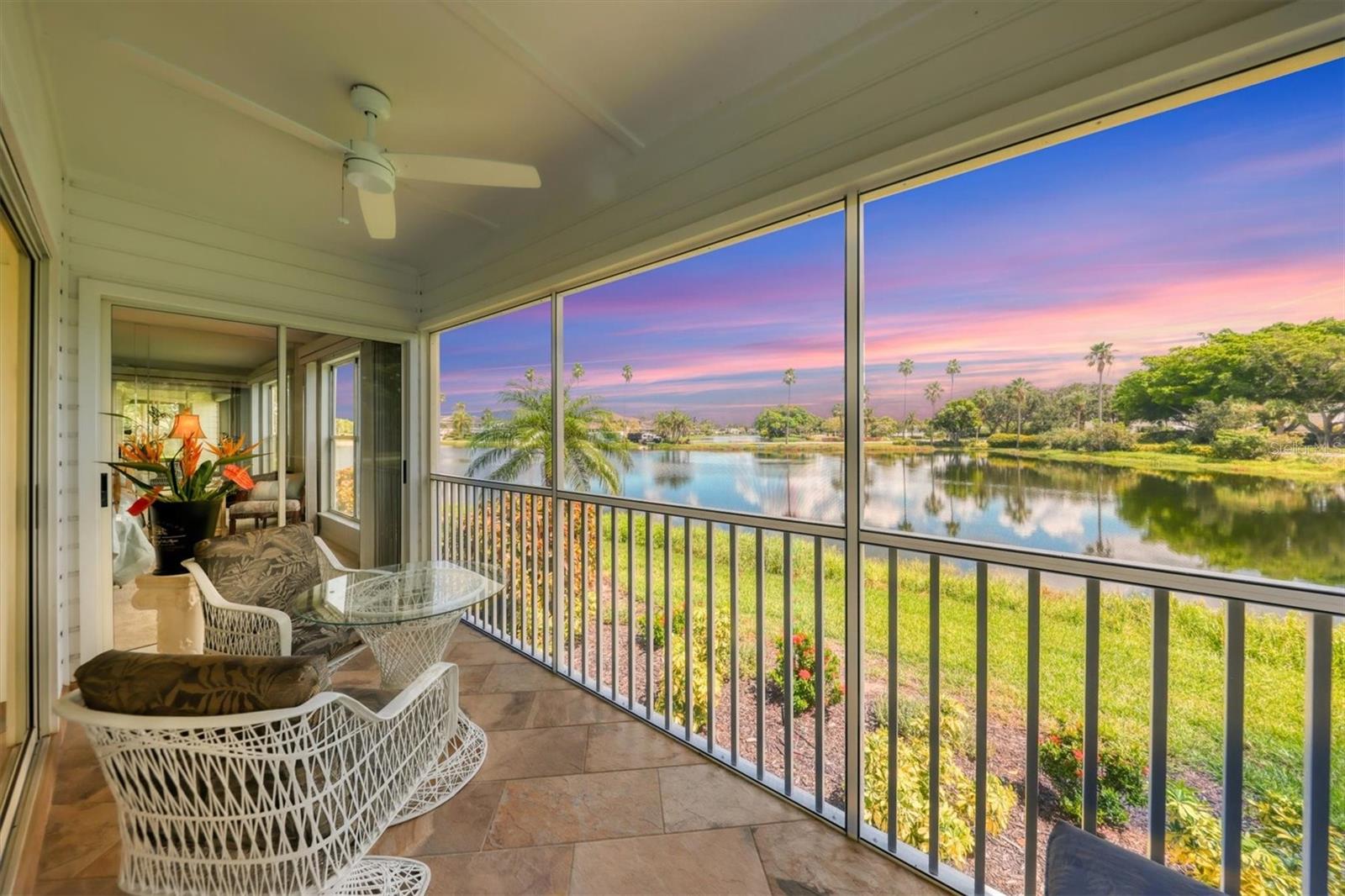 Experience the ultimate sub-tropical oasis in the highly sought-after, gated community of Perico Bay Club (PBC). From the moment you enter this beautifully designed 2-bedroom, 2-bathroom condo, you are greeted by abundant natural light and serene water views from all but one window in the entire condo. Offered turnkey furnished (minus a small list of staging items), this residence features a highly desirable split floor plan that maximizes privacy. The spacious primary suite boasts an ensuite bath with a walk-in shower, custom walk-in closet, and direct access to the private screened porch via a sliding door. Step outside onto the porch from either the living room or primary bedroom to unwind and take in peaceful lake views. Additional conveniences include an inside laundry room and an assigned carport space with ample guest parking.  Located in Shoreline Terraces of PBC, residents enjoy a dedicated community pool and spa, fully funded reserves, and a meticulously maintained exterior. The greater Perico Bay Club amenities elevate your Florida lifestyle with a junior Olympic lap pool, fitness center, clubhouse, tennis and pickleball courts, kayak launch, and a community boardwalk. Perfect for outdoor enthusiasts, you are steps away from Robinson Preserve’s extensive biking and walking trails, and just minutes across the bridge from the world-renowned, sugar-sand beaches and turquoise waters of Anna Maria Island. All dimensions are approximate and should be verified by the buyer.