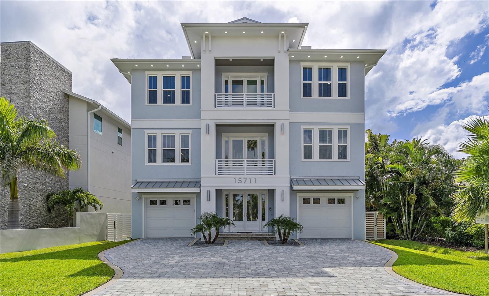 Exceptional Custom-Built Home on Protected Water in Redington Beach! This stately home offers open water views and an immense 70-foot dock with a 20K lbs boat lift. Constructed to the highest standards, this newly built residence provides hurricane protection and energy efficiency. Situated in a desirable section of Redington Beach on protected water, just 2 blocks from the nearest beach access and minutes to the Gulf of Mexico by boat! As you enter this stunning property, you'll notice coastal-inspired decor, showcasing soft neutrals, shiplap accents, and light oak hardwood flooring that extends from the formal foyer entry through the living spaces. Take the 3-stop elevator, or ascend the stairs to the main living area, which boasts expansive water views through a wall of sliding glass doors. The extended veranda, offering 400 sq ft of covered outdoor space, overlooks the bay and Intracoastal, and features travertine flooring and lovely tongue & groove ceilings. The chef's kitchen is designed to impress, with ceiling-height cabinetry, KitchenAid appliances, a custom range hood, and Butler’s pantry with prep sink. Entertain while preparing fabulous meals at the immense central cooking island. Just beyond is the formal dining room with access to the front balcony. The primary bedroom, located on the main living level, includes veranda access and a luxurious spa-like bathroom with a wet room, immense double vanity, & a huge custom-built California closet. Additionally, there is a spacious office and a full bath on this level. Ascend the stairs or elevator to the top level, where you will find 3 spacious guest rooms, a 2nd living area, & convenient laundry room. 2 of the guest rooms share a Jack & Jill bath, while the 2nd suite, with a private bath, is separated by a West-facing balcony. The upper-level family room offers water views & sliding doors leading to an immense veranda, providing 1,000 sq. ft. of entertaining space and an observation deck with stunning Intracoastal, sunrise, and sunset views. This upper veranda is plumbed with a natural gas hookup, offering ample space to build an outdoor kitchen. The ground level, accessible by elevator or primary stairs, features a spacious 2,170 sq. ft. garage/storage area large enough to house 4+ vehicles, with two 8’ overhead garage doors. Impact sliders lead to the lower-level veranda & pool area. The custom designed heated pool offers a sun shelf and spa, perfect for lounging and enjoying the waterfront lifestyle! Enjoy a state-of-the-art Pentair pool system with LED lights, jets, a spillover spa, and bubblers, all controlled from an app on your phone. Additionally, there is a gas stub on the ground level veranda for grilling or outdoor kitchen. This home showcases an incredible 70-foot dock with composite decking, a 20K lbs boat lift, shore power, water, fish cleaning station, and built-in bench. This boater’s dream dock is ideally located on protected water, just mins from Johns Pass & the Gulf of Mexico. Convenient beach access at 158th Ave just 2 blocks away across Gulf Blvd! Add’l features: Whole-house Generac generator, tankless Rinnai water heaters, Soffit Lighting, 10’ ceilings, 8’ solid core interior doors. The construction features 100% masonry & concrete, piling foundation, high-performance dual-zoned A/C systems,  impact windows & doors, closed-cell foam insulation, and level 5 drywall finish. Seawall 2018. Don’t miss your opportunity to own this incredible piece of paradise!
