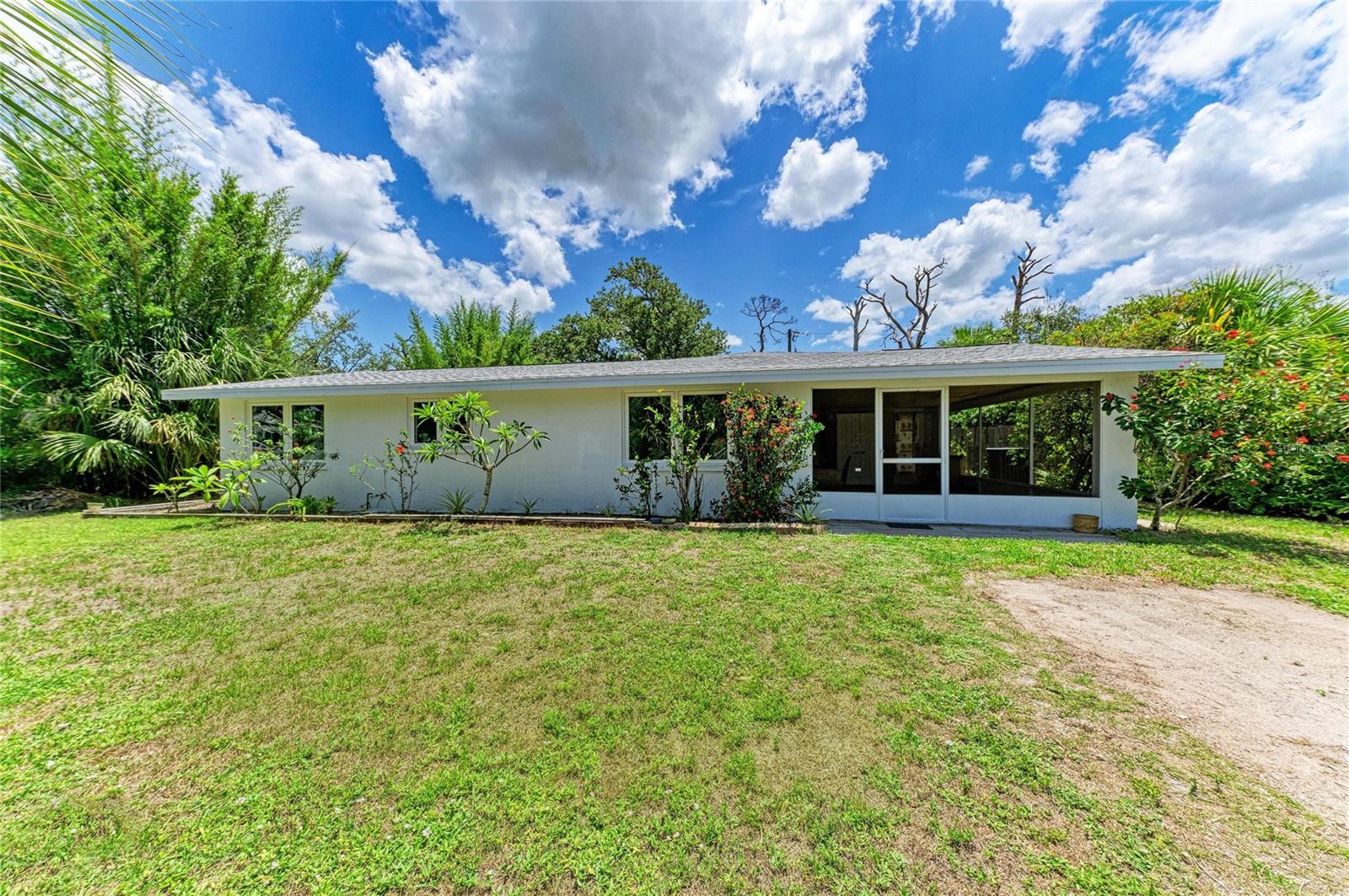Tucked into the established Grove City Terrace community of Englewood, this well-maintained 3-bedroom, 2-bath home with a versatile den offers a rare mix of privacy, updates, and true Old Florida character. The showstopper is the backyard: it shares its boundary with 50+ acres of wooded, county-owned preserve land, creating a quiet, natural setting where native landscaping and abundant wildlife take center stage — a genuine retreat for those who value peace and privacy. Inside, easy-care tile floors run throughout (absolutely NO CARPET) and hurricane impact windows deliver year-round peace of mind and efficiency, all wrapped in an open, light-filled floor plan. Added flexibility comes from a room with its own private entrance, offering great potential for an in-law suite. The big-ticket items are already handled: shingle ROOF (3 years), water heater (3 years), HVAC (8 years), and a 1-year-old microwave and dishwasher, all on solid block construction. A screened area provides the perfect spot to relax and enjoy the outdoors bug-free. Residents enjoy a community boat ramp on Oyster Creek with quick access out to Stump Pass and the Gulf. You're just minutes from the sugar-sand beaches of Manasota Key, plus Englewood's historic Dearborn Street shops and farmers market, waterfront dining, golf, world-class fishing, and the relaxed coastal lifestyle that makes this stretch of Southwest Florida so beloved. Come see it before it's gone.