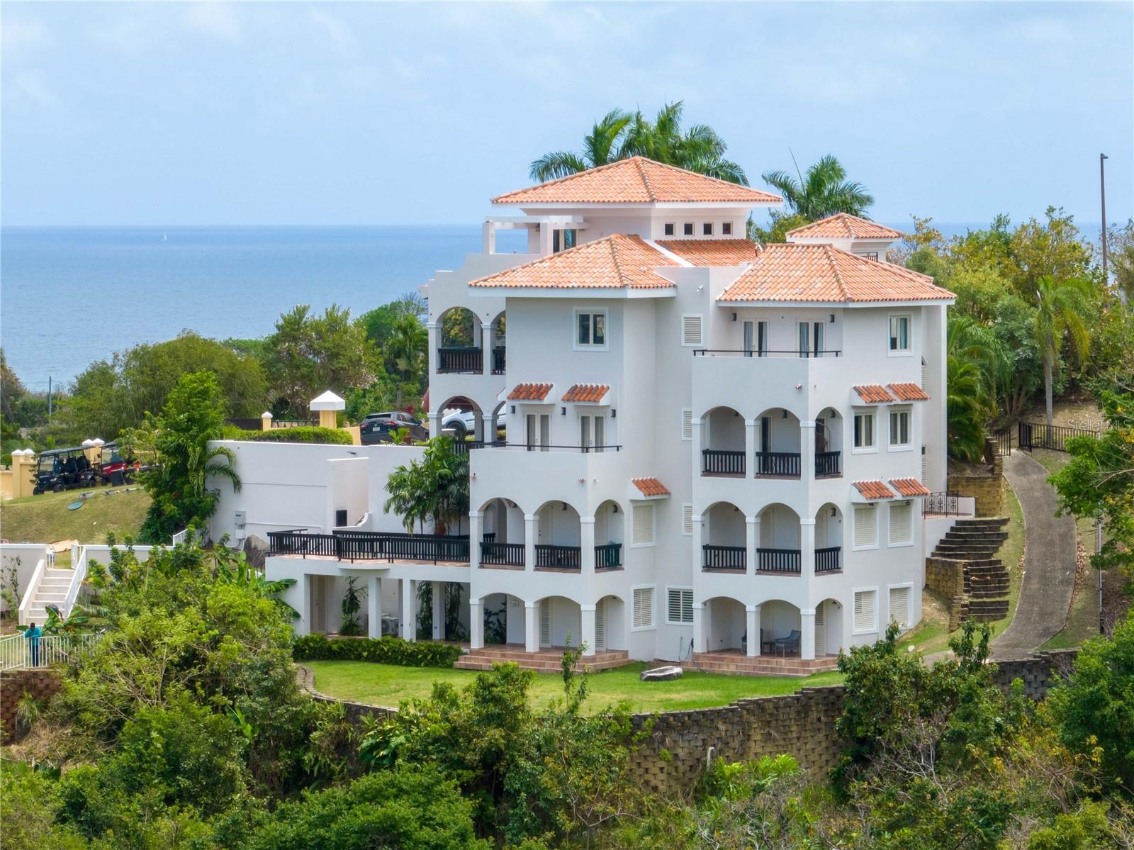 Welcome to a one-of-a-kind home in the heart of Palmas del Mar! This stunning 4-story home boasts exceptional features that make it a standout investment. Each floor is designed as a self-contained unit with its own kitchen and laundry room, perfect for multifamily living or rental income potential.

Starting from the bottom, the first floor offers a spacious one-bedroom apartment with a comfortable living room with a sofa bed, a fully equipped kitchen, a separate dining area, a private bathroom, a generously sized bedroom, and a convenient laundry room. Moreover, this floor provides direct access to the backyard, offering endless possibilities, such as adding a refreshing pool or creating an outdoor oasis for relaxation and entertainment. The mountain view from this floor are impressive!

Ascending to the second floor, you'll discover a charming 2-bedroom, 2-bathroom apartment featuring a well-appointed kitchenette, a dedicated laundry room for added convenience, a private terrace ideal for enjoying the Caribbean breeze, and a large balcony that showcases breathtaking mountain views, making every moment spent outdoors a true delight. From this floor up, the units are connected and accessible with an elevator.

The third floor continues to impress with another thoughtfully designed living space, including a cozy living room, a spacious kitchen with ample storage and counter space, two comfortable bedrooms, and a Jack-and-Jill bathroom, plus a half bathroom. This floor also boasts a private balcony, providing a perfect spot to unwind and soak in the panoramic vistas surrounding you. From this level up, you can enjoy the extraordinary mountain, ocean, and marina views.

Finally, the fourth-floor crowns this magnificent home with a stunning terrace, offering unparalleled views of Palmas del Mar and beyond. This expansive outdoor area is ideal for hosting gatherings, enjoying sunsets, or simply basking in the tropical ambiance that defines Puerto Rico living. The master bedroom is located on this floor with its ensuite bathroom plus a half bathroom for guests, as well as the living room, dining room, and kitchen with an open layout concept, as well as a loft that is currently used as a home gym, but could also be an office.

Additionally, this property features convenient amenities such as dedicated parking, easy access to nearby attractions, and the vibrant Palmas del Mar community amenities, including golf courses, tennis courts, beach access, dining options, and more.

Don't miss this rare opportunity to own a versatile and income-generating property in Palmas del Mar. Schedule your private tour today and experience the luxury and potential this home has to offer!

Palmas HOA: $1,042/year
CRIM (Property taxes): $4,546/year ($3,221/year w/exemption)