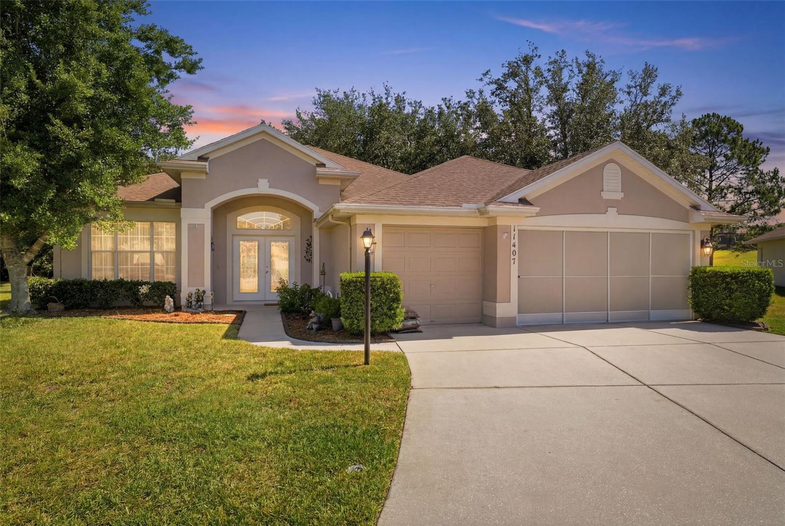 Located within the gated 55+ community of Wellington at Seven Hills, this well-maintained 4-bedroom, 3-bath home with a 3-car garage is situated on a 0.26-acre cul-de-sac lot and offers generous living spaces. Double French doors welcome you inside, where a spacious living room opens with wood-look luxury vinyl flooring that extends throughout much of the living area, complemented by high ceilings, crown molding, a convenient coat closet, and front-facing windows that bring in natural light. To the right, the formal dining room continues the same flooring and elegant crown molding, creating a welcoming setting for gatherings and special occasions. Further into the home, the family room serves as the heart of the residence and features custom white built-in shelving and cabinetry, along with a wide sliding glass door that opens to the Florida room and enhances the home's open flow. Adjacent to the family room, the kitchen combines style and practicality with a tray ceiling, abundant cabinetry, stainless steel appliances, a breakfast bar, and a built-in pantry. Nearby, the breakfast nook provides a comfortable space for casual dining and overlooks the family room through a large interior window, helping keep the living spaces connected. Privately positioned, the primary suite features carpet flooring, a tray ceiling, a spacious walk-in closet, an additional built-in closet, and a spacious en-suite bathroom. The bathroom includes a soaking tub positioned beneath a window, a dedicated vanity area, solid wood cabinetry, and a step-in shower with a textured glass enclosure. Bedroom 2 features carpet flooring, a vaulted ceiling, and a built-in closet, with a nearby guest bathroom offering a single vanity and tub-shower combination. Bedrooms 3 and 4 continue the comfortable design with carpet flooring, vaulted ceilings, and built-in closets, while Bedroom 4 is currently being utilized as a flex room or home office and benefits from natural light through its windows. Conveniently located between these bedrooms, the third bathroom features a single vanity and a tub-shower combination with white tile accents. The laundry room offers overhead cabinet storage, countertop workspace, a built-in clothes hanging rack, and direct access to the garage for everyday convenience. At the rear of the home, the expansive enclosed Florida room provides an exceptional additional living space with tile flooring, high ceilings, an abundance of windows overlooking the backyard and wide open greenspace beyond, and a hot tub that conveys with the property, creating the perfect place to relax while enjoying peaceful views of the mature trees. Residents of Wellington at Seven Hills enjoy a gated community atmosphere along with access to nearby shopping, dining, medical facilities, and recreational opportunities. Local attractions include Weeki Wachee Springs State Park, known for its crystal-clear waters, kayaking, and live mermaid shows; Pine Island Park, offering Gulf Coast sunsets and waterfront recreation; and the Suncoast Parkway, providing convenient access to Tampa and surrounding areas.
