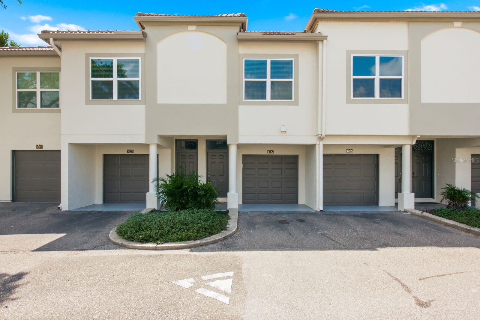 Harbour Island is one of Tampa's most coveted addresses, and this two-bedroom, two-bath townhouse-style condo at Island Walk puts you right in the middle of it. Walk to Amalie Arena, cross over to Water Street and the Riverwalk, or just settle into being tucked deep in South Tampa. The location does most of the talking here.

Inside, the two-story layout works in your favor. Garage and entry sit on the ground floor, while the living space, both bedrooms, two full baths, and in-unit laundry are all upstairs, away from street noise. The home has been nicely updated throughout, with quartz countertops and a smart fridge in the kitchen. HVAC was replaced in 2020. A screened porch gives you outdoor space without the full Florida sun, and the lot sits on the channel with a conservation view, so what's out back is water and green space instead of another building.

Community amenities are resort-caliber: two pools, a jacuzzi, a fitness center with a dedicated cardio room, tennis courts, and a playground. The HOA covers water, grounds maintenance, pool care, and valet trash pickup, and the community is gated with RFID entry.
Zoned for Gorrie Elementary, Wilson Middle, and Plant High School. Pets welcome, no buyer approval required. Harbour Island doesn't open up like this often, especially with a channel view attached.