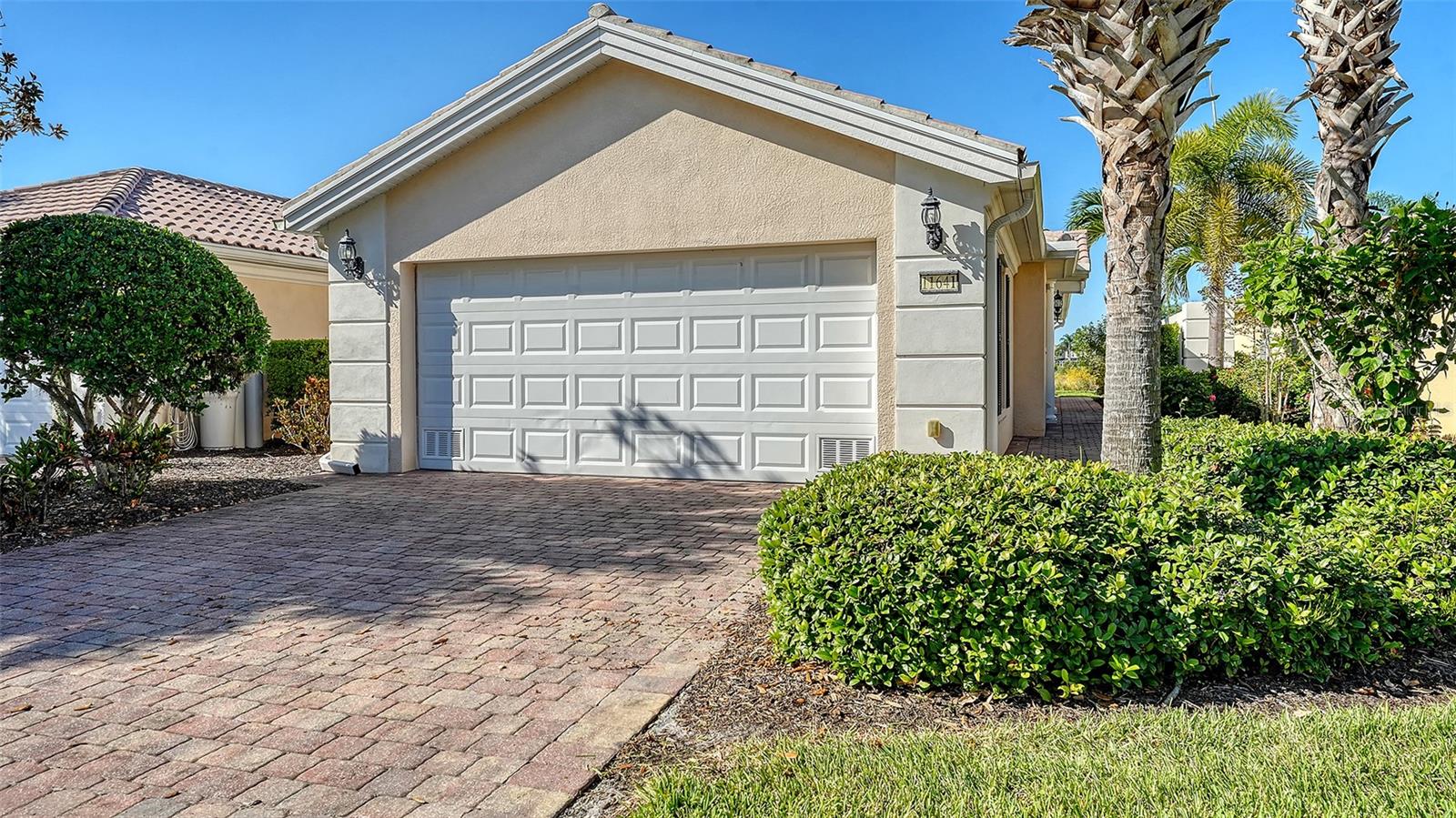 This is the One!!! Welcome to your dream retreat in the heart of Palmer Ranch, Sarasota! This beautifully maintained 2-bedroom, 2-bath villa offers a serene pond view and comes turnkey furnished, ready for you to move right in. Step inside to discover soaring high ceilings, elegant plantation shutters, and rich wood flooring in the bedrooms that add warmth and charm. The open-concept living area is complemented by a brand-new GE refrigerator and microwave, offering modern convenience in a well-appointed kitchen. AC was replaced in 2021. Enjoy peace of mind with hurricane shutters, and appreciate the ease of a spacious 2-car garage. The community offers resort-style amenities, perfect for both seasonal and full-time living. Located just minutes from the world-famous Siesta Key Beach, Isles of Sarasota is known for its lush landscaping, walking trails, and proximity to shopping, dining, and recreation. Don’t miss this opportunity to own a piece of paradise in one of Sarasota’s most sought-after communities!