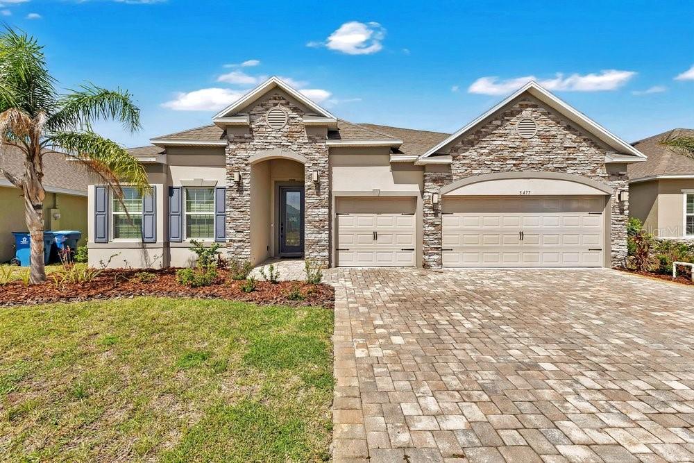 YOUR CHANCE TO OWN THE FORMER MODEL.  Homes like this simply can't be built anymore. This Venice floorplan by Maronda Homes boasts $59,000+ in builder upgrades, and it would cost far more to replicate today! Perfectly positioned in the gated community of Courtyards at Waterstone in Palm Bay, this floorplan is no longer available to build or purchase in any Palm Bay community. If you tried to build it on a scattered lot, you'd wait 9 to 12 months for completion. . . and still wouldn't have access to some of the now-discontinued upgrades this one offers. This home is move-in ready, BETTER THAN NEW and FULLY LOADED WITH UPGRADES.
From the moment you step inside, soaring ceilings and elegant TRAY CEILING WITH CROWN MOLDING define the entry, living, dining, kitchen, and primary suite. An abundance of windows floods the home with natural light, and an upgraded front door welcomes you in. This sprawling 4-bedroom, 3-full-bath layout lives large, with custom interior paint, a deluxe trim package, and upgraded light fixtures, LED lighting, and pendant accents throughout.

Two generously sized bedrooms sit at the front of the home, while a third is tucked privately down a hallway near the laundry room.  Complete with its own full bathroom, walk-in shower, and walk-in closet. It's the PERFECT MOTHER-IN-LAW SUITE setup or private retreat for guests. At the heart of the home, the Level 2 GOURMET KITCHEN is built to impress: upgraded countertops, double ovens, a tile backsplash, under-cabinet lighting, a French-door stainless counter-depth refrigerator, and an oversized pantry — all wrapped in a warm, neutral palette. The luxurious primary suite overlooks the lake and features an oversized closet and a SPA WORTHY EN-SUITE BATH h with a garden soaker tub framed by a window, an oversized fully tiled Level 3 shower with bench seating, and a triple shower head system including rainfall. Secondary baths are equally elevated, with upgraded tile, modern bronze hardware, and frameless glass doors with black trim. Ceramic modern tile flows through all the main living areas. The laundry room is a dream of its own, with upgraded wall cabinetry, a sink, and washer and dryer included. The living, dining, and kitchen areas all open to an extended, screened lanai with SERENE WATER VIEWS . . . perfect for relaxing or entertaining. The exterior makes a statement of its own with a spacious 3-car garage, pavered driveway and walkway, handsome stone and brick accents, hurricane shutters for storm-season confidence, and lush sod nourished by cost-saving well irrigation. Living at Courtyards at Waterstone means resort-style perks: a gated entrance, community pool and cabana, and a low HOA fee. You're just minutes from the Publix plaza, only 5 minutes to I-95, and within walking distance of Sunrise Elementary. BETTER THAN NEW, packed with upgrades, and impossible to replicate at today's price.  This is the one you've been waiting for. Schedule your tour today.