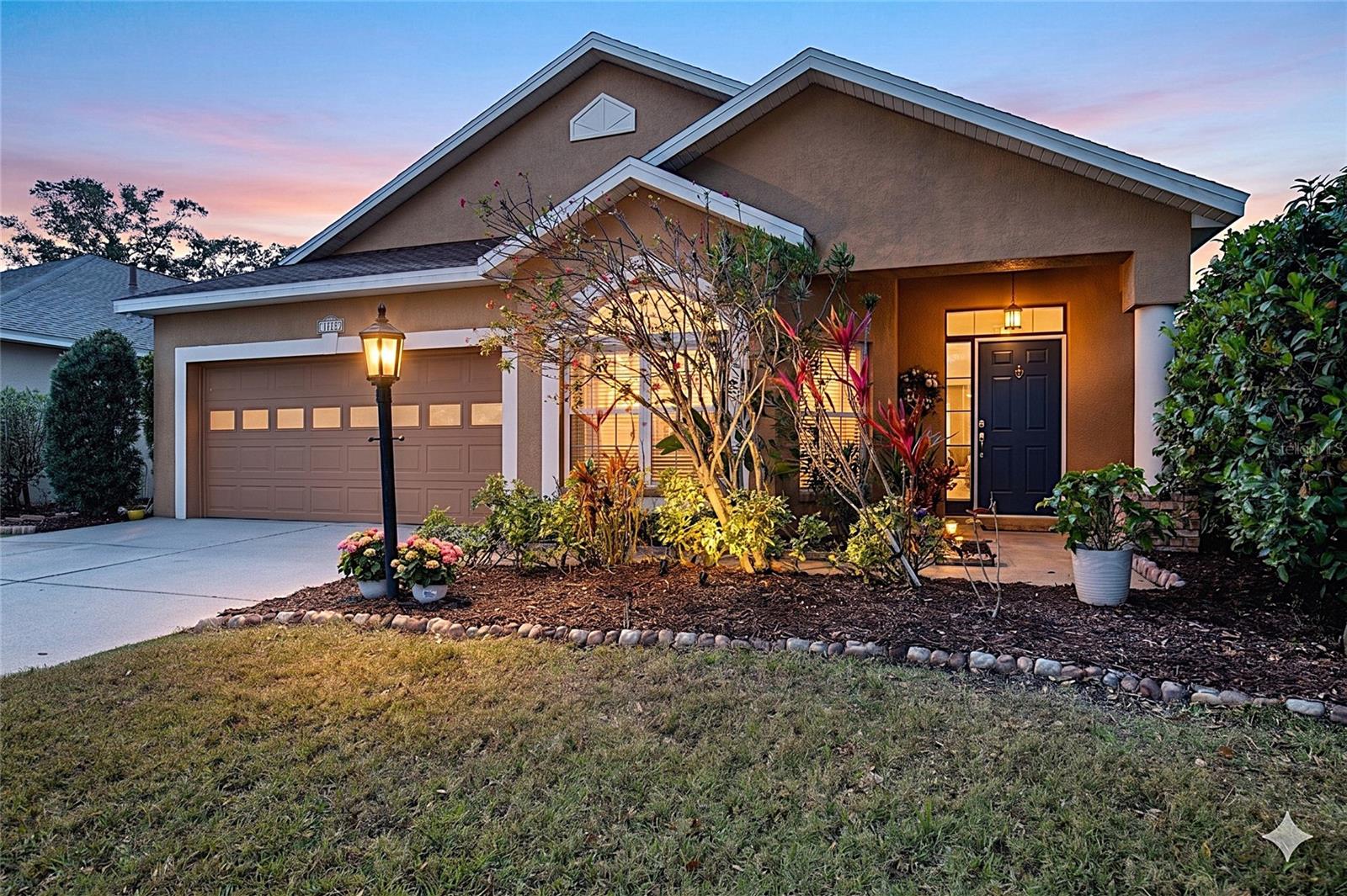 One or more photo(s) has been virtually staged. Looking for a place that feels like home the second you pull into the driveway? Tucked away on a charming, tree-canopied street, this beautifully maintained RIVERWALK VILLAGE residence puts you right in the heart of LAKEWOOD RANCH. Inside, the vibe is bright and airy, with an open layout that flows effortlessly from the spacious family room into separate living and dining areas. The kitchen is a total standout, featuring a SKYLIGHT, sleek STONE COUNTERS, crisp white cabinetry, and a CONVENIENT ISLAND for your morning coffee. You’ll find easy-care laminate flooring throughout the main spaces, while the primary retreat offers peaceful views of the SPARKLING POOL. Step outside to an oasis designed for relaxation, complete with a RUBBERIZED POOL DECK and a fully FENCED YARD. Best of all, you can move in with total peace of mind thanks to a BRAND-NEW AC AND WATER HEATER (2025) and a NEW ROOF (2017). Whether you’re biking to the boutiques at MAIN STREET or exploring nearby nature trails and UTC SHOPPING, this is a rare chance to join a friendly community in a location that truly has it all.