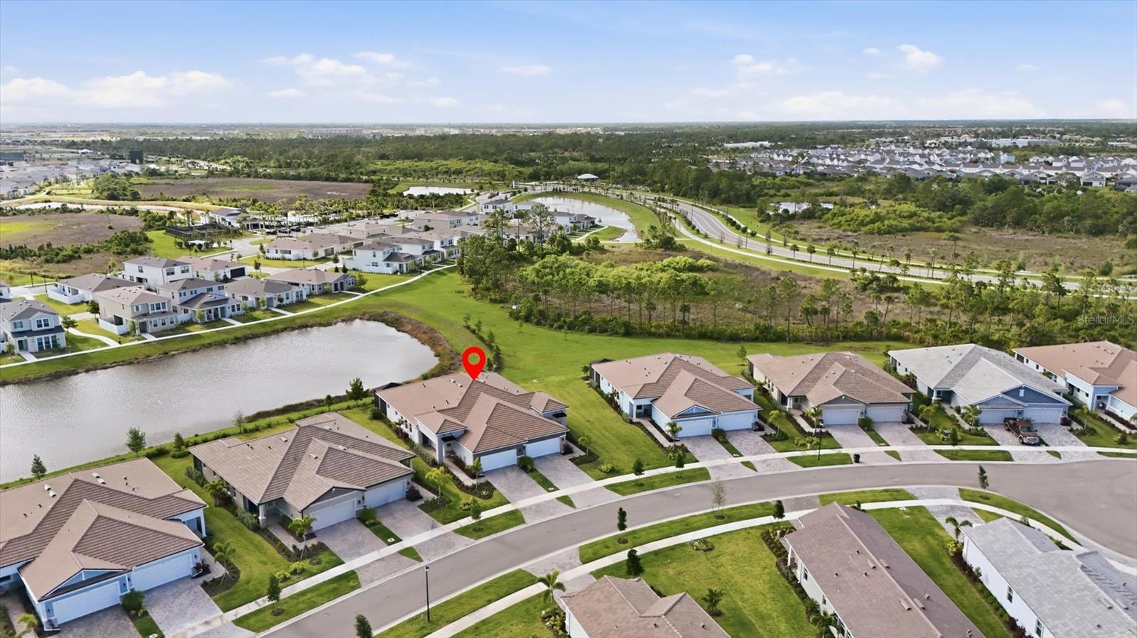 Welcome to Wellen Park’s sought-after Brightmore community, where this better-than-new Champagne Traditional paired villa stands out with extensive upgrades, thoughtful enhancements, and a premium lake view—without the wait or added expense of new construction.

Built in 2024, this meticulously upgraded home features a bright, open-concept layout with a seamless flow between the kitchen, dining area, and great room. Every detail has been elevated beyond builder standards, including tile flooring throughout the main living areas, plantation shutters, upgraded lighting and ceiling fans, and abundant natural light.

The kitchen has been beautifully enhanced with upgraded stainless steel appliances, 42" cabinetry with under-cabinet lighting, pull-out drawers for added functionality, and a clean, modern finish that blends both style and convenience.

Step outside to a new extended upgraded lanai experience—complete with pavers, a covered seating area, Super Screen enclosure, and sliding glass doors with retractable blinds. Enjoy peaceful lake views in a space designed for true indoor-outdoor living. Additional exterior upgrades include enhanced landscaping, Storm Smart electric hurricane shutters on the lanai and a retractable front door screen.

This home is loaded with high-value upgrades already completed for you, including impact windows and doors, a smart home technology panel, a fully outfitted laundry room with added cabinetry, and an extended two-car garage with epoxy flooring—features that are often costly add-ons in new builds.

Residents of Brightmore at Wellen Park enjoy an exceptional lineup of resort-style amenities, including a spa, resort-style pool, and dedicated lap pool, along with a vibrant clubhouse featuring a fitness center, library, and card rooms. The community also offers a café, restaurant, and bar, perfect for casual dining and social gatherings.

Outdoor amenities are equally impressive, with over 20 miles of scenic walking and biking trails, the stunning 80-acre Grand Lake, bocce ball courts, a dog park, and eight pickleball courts plus a stadium pickleball court for tournament-style play. Relax and unwind at the community fire pits or take in the beautifully designed gathering spaces that make Brightmore an active and engaging place to call home.

Located just minutes from shopping, dining, and the exciting Downtown Wellen Park district, this home offers the ideal combination of move-in-ready convenience, premium upgrades, and resort-style living—without the delays, added costs, or uncertainty of building new.