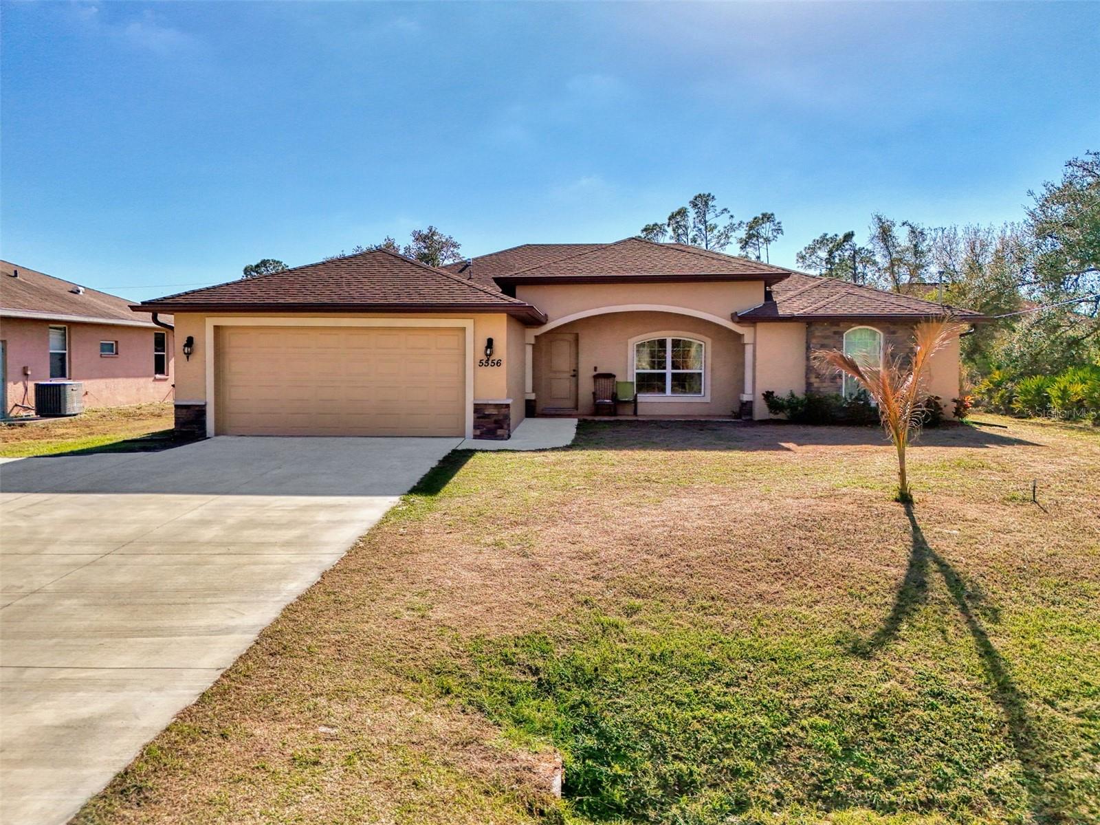 “2023” WINDERMERE QUALITY BUILT 3/4 Bedrooms, 2 baths, 2 Car garage including a large Den/Office (13x15.5) with built-in desk area that can be a 4th bedroom or hobby room! CITY WATER! NO FLOOD ZONE! UPGRADES! HURRICANE PROTECTED! This home offers over 1,600 sq. ft. of luxury living with an impressive BRICK STONE EXTERIOR front siding that adds charm and timeless style. A welcoming 19x6 front porch, ready to be screened in, sets the tone for relaxed Florida living. Around back, enjoy an 18x10 covered screened lanai—perfect for soaking up the sunny, warm weather all year long. Step inside to a bright open floor plan designed for both comfort and function. The large granite center island kitchen overlooks the spacious 22x21 Great Room and dining area with soaring cathedral ceilings, creating a grand yet inviting space. PLANK TILE FLOORING runs throughout the home for a clean, modern look and easy care. The kitchen is loaded with upgrades, including wood cabinetry with crown molding, granite countertops, tiled backsplash, pendant lighting, a large pantry, and a Lazy Susan for smart storage. This is a true chef-inspired kitchen and a beautiful focal point for everyday living. The primary bedroom measures 15x13 and features a huge walk-in closet with a custom wooden clothes organizer. The private ensuite bath includes a tiled walk-in shower and a granite vanity with dual sinks for added comfort and style. Two additional guest bedrooms, each 11x12, offer roomy space and flexibility. The guest bath includes a granite top vanity and a tiled tub/shower combination, with direct access to the lanai—ideal as a future pool bath. An inside laundry room adds convenience with a full-size washer and dryer, built-in wet sink, and extra storage cabinetry. The oversized 2-car garage features a painted floor, tool wall, hurricane-rated garage door, and hurricane shutters stored inside. Even better, the seller only pays $938 for home insurance, adding serious value. Furniture negotiable! Located just minutes from the Toledo Blade I-75 entrance, SCTI, shopping, schools, parks, Town Center Mall, and only a 20-minute drive to sandy white beaches. This move-in ready Florida home checks all the boxes. Call today for your private showing!