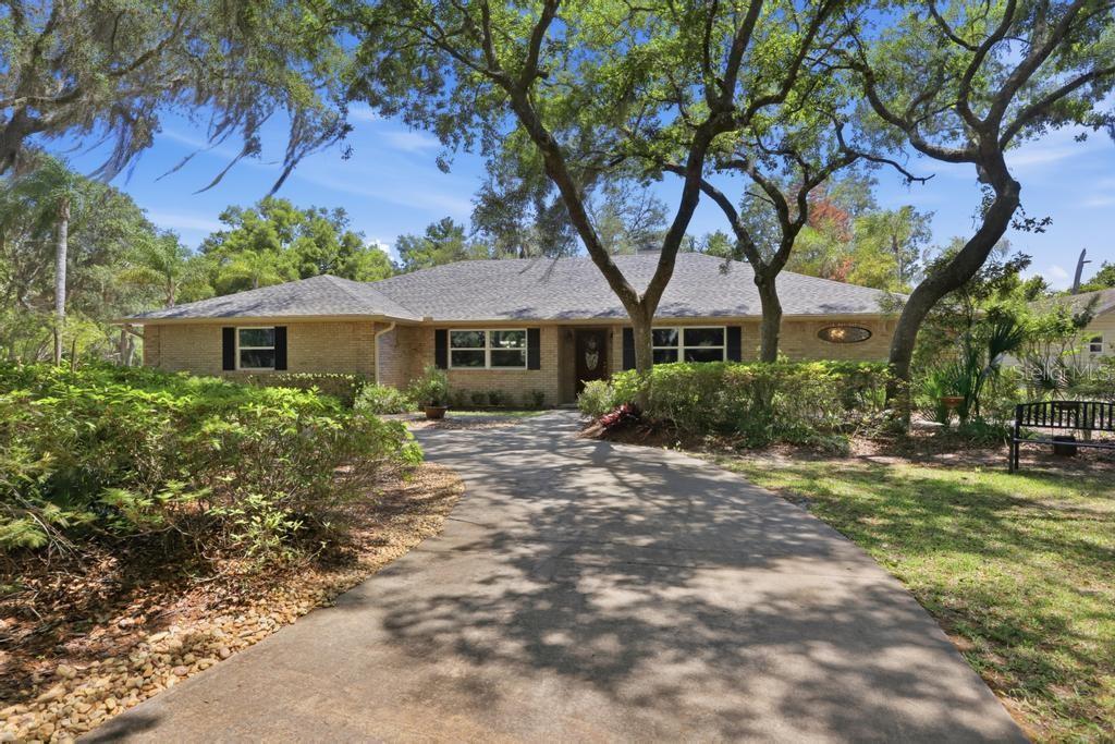 Tucked away is this hidden gem in the Lake Ruby area of DeLand, this incredible 2.5-acre property on Krinklewood Drive has everything you have been looking for. Nothing has been left undone in this beautiful ALL BRICK POOL home offering privacy, space, and endless possibilities. Bring your RV, boat, recreational toys, or create the workshop you have always dreamed of with the impressive 20x35x12 metal building. There is also a second detached garage/workshop complete with power, water, and plumbing for a future bathroom setup.
Outdoor living is truly exceptional. Surrounded by beautiful trees, azaleas, and occasional deer’s feeding in the early mornings. The screened pool area is fully fenced, while an invisible fence allows your pups to roam freely across the property. Have you been dreaming of having CHICKENS? Wait until you see the charming chicken coop and free-roaming area — and even better, the chickens can stay!

As you enter the home, you will immediately appreciate the open-concept split floor plan. A private den/office with French doors. A formal dining area showcases beautiful custom built-ins for additional storage. The spacious living room features a traditional wood-burning brick fireplace and French doors leading to the pool lanai, allowing for the perfect indoor and outdoor space for entertaining.
If you love to cook and entertain you will appreciate this kitchen. Overlooking the backyard and pool area, the kitchen features stunning white cabinetry, quartz countertops, stainless steel appliances, double ovens, a large pantry, center island, coffee bar, and a bright breakfast nook. The owners recently completed a stunning renovation of the primary bathroom featuring dual vanities, a walk-in shower, garden tub, and private water closet. The spacious primary suite also offers its own flex space with direct access to the screened pool patio, creating the perfect retreat for an office, sitting room, or fitness area. The split-bedroom layout provides privacy with two generously sized guest bedrooms and a beautifully renovated guest bathroom. The oversized utility/laundry room offers additional storage space along with a convenient soaker tub.
This one-of-a-kind property offers the perfect combination of country living, with city conveniences just 10 minutes to shopping, dining and downtown DeLand.
Roof  2021. AC System 2022, Water Heater 2025, Seimens Panel Box,  Windows 2023, Pool pump moter & filter system 2025, Softwater Sytems is owned.