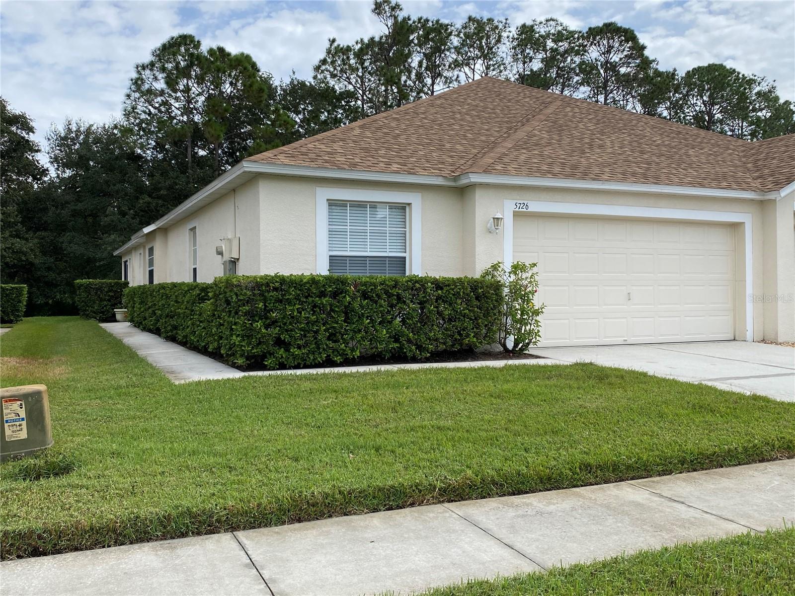 This beautiful 3 bedroom villa with golf course view is loaded with upgrades and ready to move in!  NEW ROOF 2022, A/C 2022, HOT WATER TANK 2023.  The chef in the family will love this gourmet kitchen featuring 42 inch cherry cabinets, stainless steel appliances, granite countertops, breakfast bar, recessed lighting, big pantry, window seat.  Opens to the large family room with tile laid at a diagonal throughout, ceiling fan and dining area.  Great for entertaining!  Come home and relax on the oversized screen enclosed covered 30 x 8 lanai with privacy wall & tranquility.  GORGEOUS VIEW ON A PREMIUM GOLF COURSE LOT!  Spacious master bedroom with sliding glass door, ceiling fan and TWO walk in closets.  Master bath features cascade maple spice deluxe cabinets with two sinks & drawers, walk in shower and tile.  Split plan with 2 bedrooms up front with bathroom featuring cascade maple spice cabinet.  Upgrades include R-30 insulation, pre wire for alarm system, water filter/softener loop, rounded corners!  Everything conveniently located on one floor.  HOA is responsible for the roof, exterior paint, landscaping and amenities.  You can just go enjoy the Florida lifestyle.  LOCATION!  LOCATION!  LOCATION!  Lake Bernadette is a fantastic community that has a public golf course, heated pool, tennis court, state of the art fitness center, party room, pickleball court, many events & activities.  Call today to view this dream home!