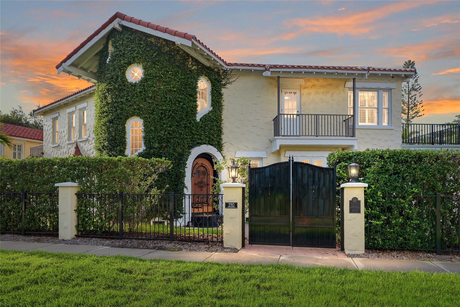 Welcome to the "Washington House," a breathtaking Mediterranean estate on the National Historic Registry and one of the first homes ever built on coveted Davis Islands. Designed by a premier architect of the era, this 1926 masterpiece has been meticulously restored and fully modernized to blend timeless architectural romance with today’s highest luxury standards. Situated on two expansive corner lots, the property is fully enclosed by a private masonry wall with gated entries, new aluminum balcony railings, and a 3 car garage. The resort style grounds feature manicured gardens, ambient LED lighting, a water fountain, a gazebo, and a sparkling pool with a charming patio and outdoor fireplace. The grand main residence (4,475 SF) showcases beautifully preserved and resurfaced original 1926 doors. An impressive original wood door opens to a breathtaking circular foyer with soaring ceilings and brand new marble flooring. The open layout flows seamlessly to a spacious formal dining room and a fully remodeled gourmet kitchen. The kitchen is equipped with rich white shaker cabinetry, a new tile backsplash, bright quartz countertops, and premium new Viking appliances. A versatile den/4th bedroom with an attached half bath sits just beyond. The opposite wing features a massive formal living room with a fireplace, a sunroom, and a large family room opening directly to the covered poolside patio. Upstairs, a staircase lined with historic casement windows leads to a serene primary suite complete with hardwood floors, three closets, a historic bath, and two private balconies. Two additional guest bedrooms (one with a front-facing sitting room, one with a private balcony) share a stunningly updated full bath, located right next to the newly renovated laundry room. Maximizing the estate's versatility is a 1,216 SF, two story guest house with two separate private entrances. The 1st floor offers 1 bed, 1 full bath, and a living area; the 2nd floor features 1 bed, a half bath and a living space. Enjoy ultimate peace of mind with extensive top tier upgrades: a brand new 3-ton HVAC and air handler with all new ductwork, updated plumbing, new interior/exterior trim paint, and upgraded modern bathrooms throughout. A true private luxury enclave!