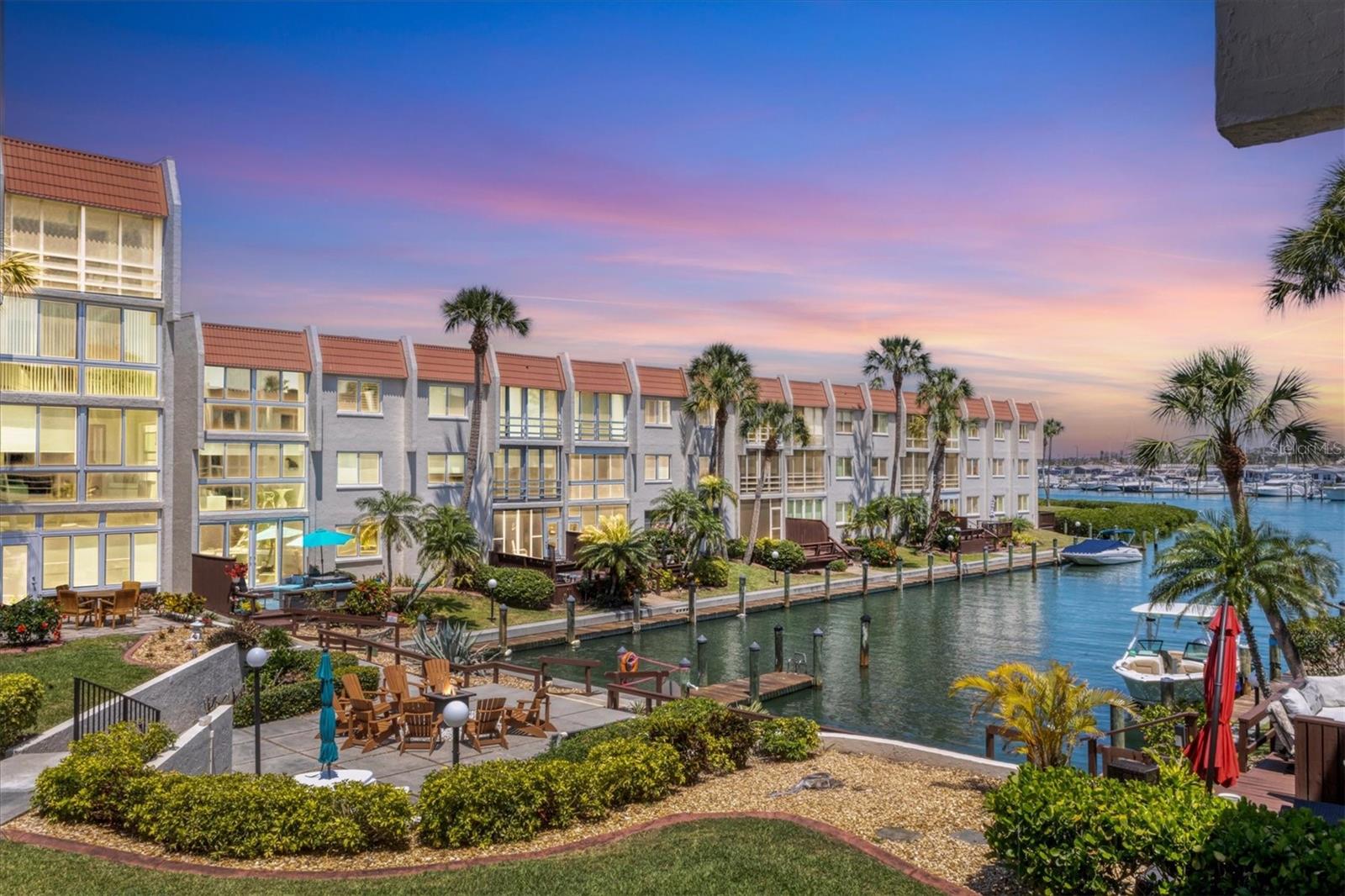 Discover the allure of VENICE ISLAND with this EXCEPTIONAL END UNIT CONDO offering a PRIME DOWNTOWN LOCATION with BOAT BASIN WATER VIEW! Situated along the Intracoastal Waterway, Bella Costa is conveniently located just two blocks from the vibrant heart of downtown Venice offering dining, shopping, Farmer's Market and events, and a quick one-mile trip to the newly enhanced Venice Beach and the Gulf's inviting waters. Enjoy free parking downtown and at the beach, and Legacy Trail just a block away, is perfect for your morning walks or bike rides north or south from the Venice trailhead. And let's not forget the breathtaking West Coast sunsets, yours to enjoy every evening with your feet in the sand. This beautifully appointed condo boasts a numerous upgrades throughout the kitchen and bathrooms, featuring tile floors and sparkling stone countertops thru out, tiled shower with frameless glass door in primary ensuite bedroom, interior stacked washer & dryer, 2021 A/C system, new 2026 Hot Water Heater and partial Turnkey Furnishings. Imagine relaxing with an iced tea on your lanai, enjoying the perfect view of the boat basin through wind-compliant windows and sliders. A unique feature is the additional room, providing flexible space for relaxation, accommodating guests, dining area or cozy den. Bella Costa also offers a resident clubhouse complete with a full kitchen and great room, ideal for hosting larger gatherings. Residents also have access to a sparkling heated pool, library, exercise room and billiards making it a wonderful retreat for you, your family and guests. The property includes a brand-new covered and assigned carports, as well as a storage closet for your beach gear, golf clubs, and bicycles. Being offered turnkey and partially furnished, this condo provides the ultimate convenience for immediate occupancy, vacation stays, or rental opportunities without any holding period restrictions. Notably, Bella Costa has successfully completed the recent MILESTONE inspections, demonstrating fully funded reserves with no structural deficiencies or pending assessments. This remarkable condo offers an incredible Venice Island opportunity!