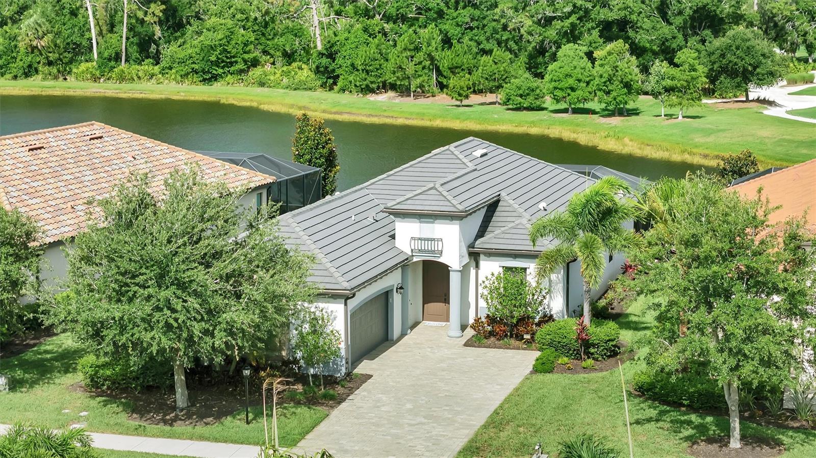 Welcome to Lakewood National Golf Cub,where resort-style living meets 36 holes of championship golf in one of Lakewood Ranch's premiere gated communities.This beautifully upgraded Victoria model offers an open-concept design with stylish luxury vinyl plank flooring in all bedrooms and den creating a warm and modern feel.The spacious great room flows seamlessly to the outdoor lanai,featuring a stunning wood ceiling and hurricane screens for year round comfort and protection.Enjoy the sunsets overlooking the lake and the 16th hole of the commander course.This home is the only model in all of Lakewood National that offers a dedicated pool bath.Residents have access to world class amenities which include;Clubhouse with fine dining,tiki bar,resort-style zero entry pool with waterfalls,pickleball,tennis,spa,and a state of the art fitness center.This location has convenient access to downtown Lakewood Ranch,sports facilities,shopping,dining and top rated schools.Lakewood Ranch has been the #1 Multi-Generational planned community for 8 years running!
