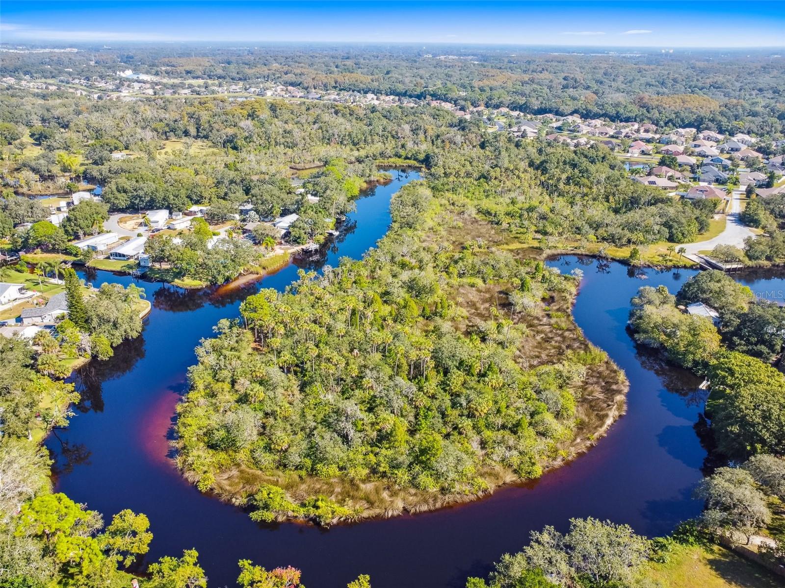 WATERFRONT! 5.3 Acres with 1900 linear ft of WATERFRONT PROPERTY ON THE ANCLOTE RIVER, DEEP WATER ACCESS LEADS DIRECT TO THE GULF! Own your own private Peninsula. This amazing property offers its owners unmatched PRIVACY and multiple layers of SECURITY! You and your guest gain access through card access security gate, followed by a short drive through the beautiful homes of Magnolia Estates, then a passcode grants you access to your property’s private drive. No mandatory HOA rules, fees or deed restrictions.  Only a 6 mile boat ride down the peaceful and tranquil Anclote River, through beautiful Tarpon Springs then you’re fishing and funning around the Gulf of Mexico. Build an incredible single family riverfront estate on this majestic peninsula and live in a small, but exclusive private community of homes.  Located just 10 minutes from downtown Tarpon Springs by car or boat! Just 35 minutes to the major downtown areas of Tampa, St. Petersburg and Clearwater. Amazing opportunity! Don’t miss it!