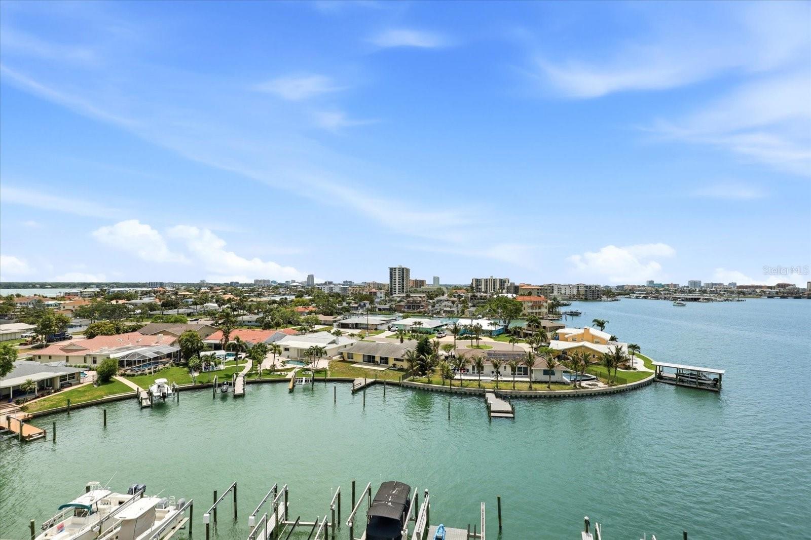 Come live the island life in Island Estates! This top floor, 2 bedroom, 2 bathroom condo, offers amazing intracoastal views! Featuring 2 balconies, you'll take in gorgeous mornings and evenings watching birds fly and dolphins play right in your own backyard. Step inside to find a bright and airy open floor plan with sliding glass doors, filling the space with natural light. The spacious living area flows seamlessly onto a private balconies, where you can enjoy stunning sunsets. The kitchen features stainless steel appliances PLUS a washer and dryer! Freshly painted walls with new fans and dining fixture add to the appeal of moving right in. Enjoy soaking up the sun year round with the community's waterfront heated pool! Take the Jolley Trolley to the beach or enjoy a bike ride to your favorite Clearwater Beach spots. The convenience of Publix located right down the street is an added bonus! This unit includes 1 covered parking space. Condo fee includes water, basic cable, internet, grounds and exterior maintenance, building insurance and reserves. Time to live where you vacation!