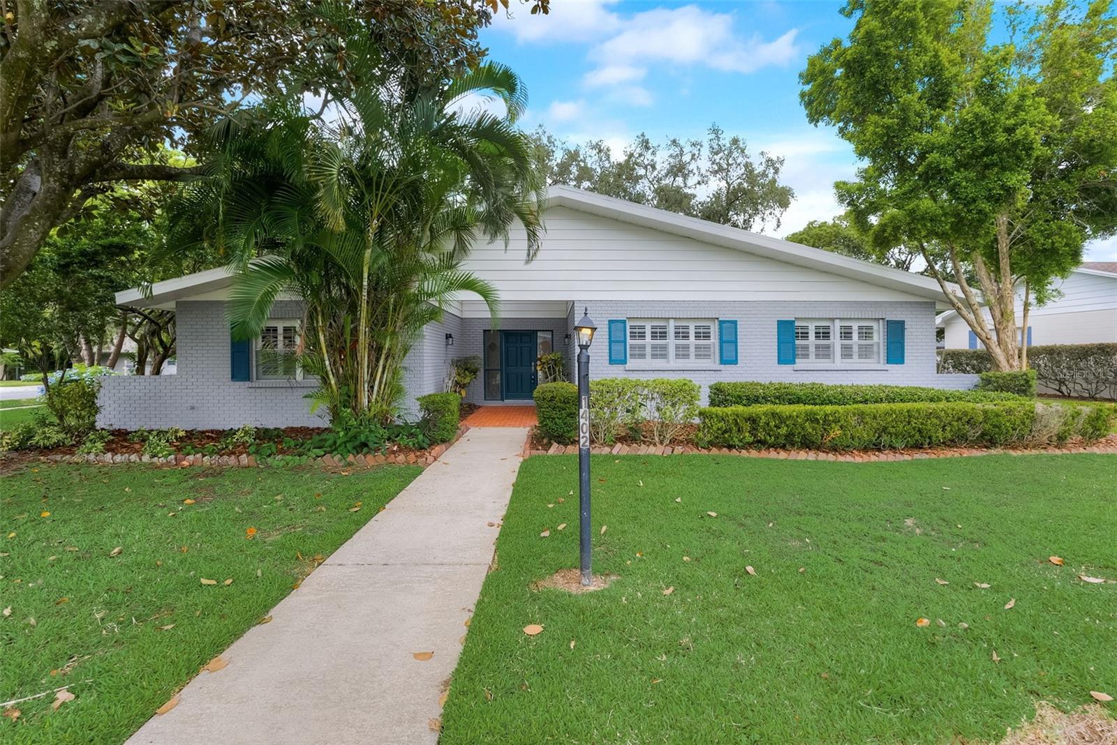 Welcome home! This wonderful 4 bedroom 3 bath POOL home is located just a quarter mile stroll from beautiful Lake Hollingsworth. As you pull up to this great home you’ll immediately notice the NEW paint, mature landscaping and that the second story roof is NEW. Step through the garden courtyard then the front door and you’ll find yourself in the living room looking out the glass sliding doors at the glistening pool water. To your left is a formal dining room, a family room with a fireplace and a completely updated kitchen that includes NEW shaker style cabinets, new gleaming granite countertops and a new stainless steel range, microwave and dishwasher. Downstairs also boasts a primary bedroom with a completely updated ensuite bathroom, 2 secondary bedrooms and an updated hall bathroom. The bathrooms both feature new granite topped vanities and new tubs and tile surrounds. Venture upstairs and you’ll find a second floor dedicated to another primary bedroom and bathroom. At it’s widest this bedroom is 24’ by 21.’ The ensuite bathroom has a granite topped dual sink vanity and the shower has been updated with all new tile. Head back downstairs and out onto the pavered porch and pool deck. The oversized pool has its own screen cage and waterfall! This is the perfect place for entertaining friends and family or just relaxing. This home is located just a quarter mile from Lake Hollingsworth and only 5 minutes from either downtown Lakeland or the delightful Common Ground Playground. Don't miss your chance to own this wonderful home - make an appointment to see it today!