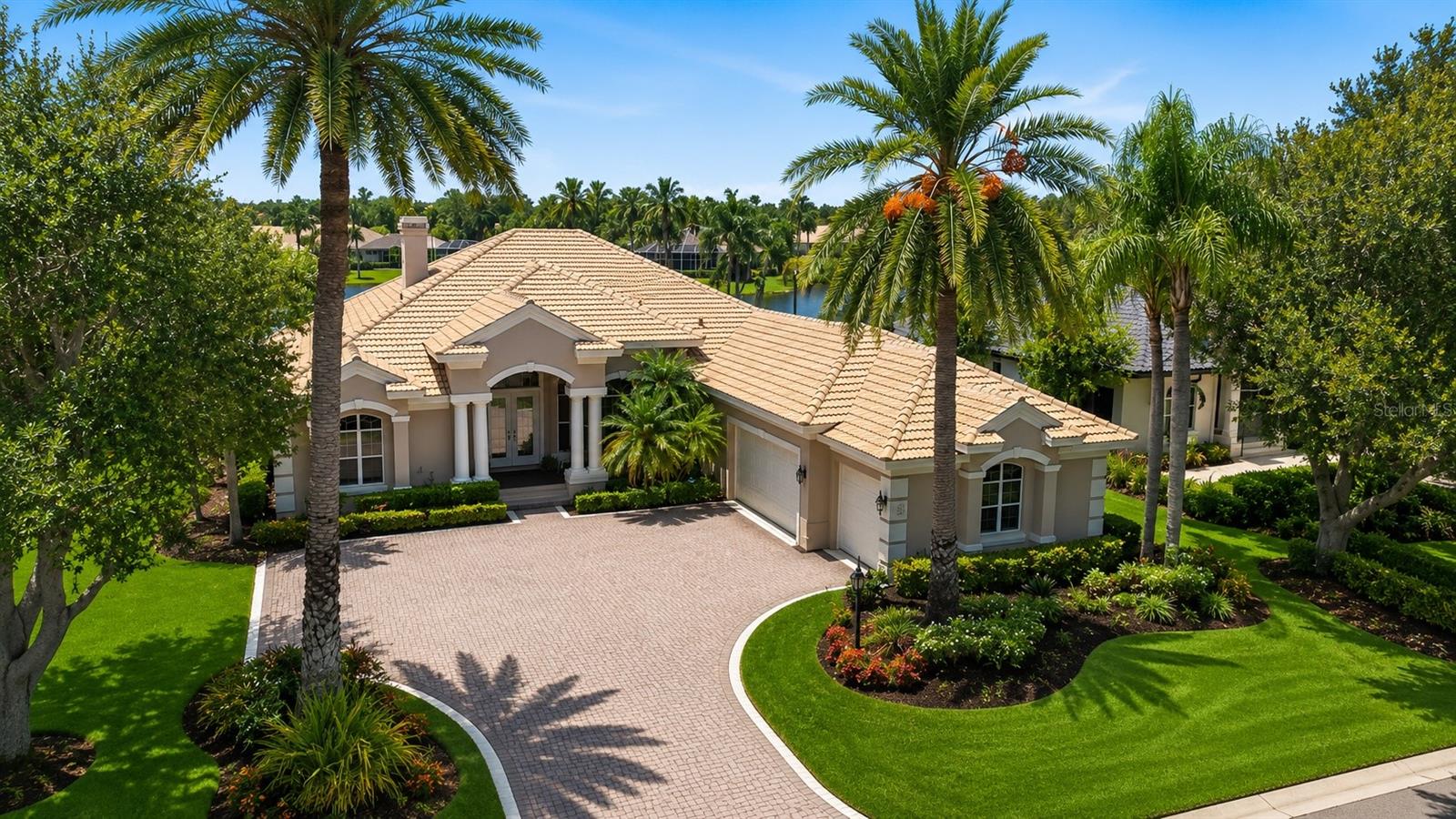 Welcome to University Park Country Club, where luxury living meets breathtaking views. This exceptional custom-built residence by renowned builder Dan Najjar designed to exceed every expectation.
From the moment you step through the front door, you are greeted by spectacular panoramic views of the lake and golf course, creating a stunning backdrop for everyday living. The thoughtfully designed open-concept floor plan features soaring ceilings, expansive living spaces, and seamless indoor-outdoor flow, maximizing both comfort and elegance.
Every detail of this home reflects superior craftsmanship and quality, from the high-end finishes and architectural details to the carefully planned layout that perfectly balances sophistication and functionality. Built with uncompromising attention to detail, this residence showcases timeless design and enduring value.
Whether entertaining guests or enjoying a quiet evening overlooking the water, this home offers an unparalleled lifestyle in one of Sarasota's most sought-after communities. This is luxury living at its finest.
EXPERIENCE The University Park With its mature landscape and sprawling natural beauty, University Park is the premier master-planned community in the Sarasota area. Behind the secured, staffed entrance is an award-winning, resident-owned community featuring 27 holes of four-star rated golf, eleven lighted Har-Tu tennis courts, four pickleball courts, a fitness center, croquet, miles of tree-lined streets for walking or biking, and first-class dining. Also offered are numerous social activities and many social clubs designed to fit a variety of interests. Located only four miles from downtown Sarasota and its spirited arts community, museums, shopping, dining, and first-class healthcare, University Park is an oasis from the City but close enough to all amenities. It's only a short 15-minute drive to some of America's finest beaches, superb outdoor recreation areas, including the internationally renowned Nathan Benderson Park, the famed Ringling Museum, various boating options, and the acclaimed St. Armands Circle. University Park's breathtaking beauty is unmatched by any other. Designed with comfort and privacy in mind, this split-bedroom floor plan offers a luxurious primary suite on one side of the home, while two additional bedrooms, a private office, and a media room are thoughtfully situated on the opposite wing. The expansive outdoor living area is destined to become your private retreat for relaxation and entertainment, complete with generous covered spaces surrounding the spectacular pool and spa. RECENT UPDATES: POOL CAGE 2025, ROOF 2024, AC 2021