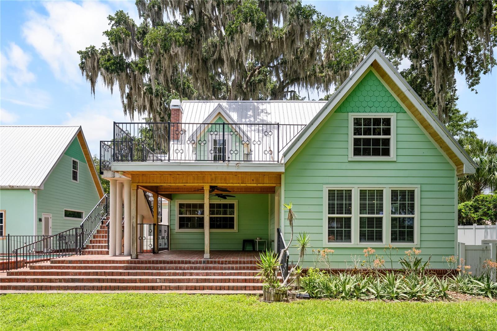 An extraordinary DeLand lakefront estate set on 5+ acres along beautiful Lake Winnemissett, offering over 7,300 SF of air-conditioned living space, including the main house, guest house, and garage showroom, plus an additional 4,000 SF air-conditioned warehouse. With an exceptional combination of living space, storage, recreation, and flexibility, this property is ideal for multigenerational living, business owners, car enthusiasts, collectors, or anyone seeking room to spread out and enjoy a truly unique lifestyle.

Outdoor living is just as impressive, with a pool, hot tub, and pool bar designed for entertaining and enjoying the Florida lifestyle. Quality and durability shine throughout with metal roofing and Hardie board siding added to the three main structures in 2018, while the expansive grounds showcase 4 acres of meticulously manicured landscaping, irrigation, mature fruit trees, and magnificent oak trees that create a private and picturesque setting.

Inside the main residence, hardwood flooring, tongue-and-groove ceilings, built-in speakers throughout, and a gorgeous fireplace add warmth and character, while two safe rooms, a spacious playroom, gaming room, and private theater provide comfort, fun, and flexibility for everyday living. For car enthusiasts or workshop use, the garage also includes two high-end hydraulic 2-post car lifts, offering exceptional storage and mechanic space. Home has whole house generator and 2 propane tanks.

With approximately 76 feet of Lake Winnemissett frontage and 135 feet of depth, this rare property also offers exciting potential to create an even more extraordinary private waterfront retreat. 2424 E New York Ave delivers a unique blend of privacy, versatility, and lifestyle that is nearly impossible to find.