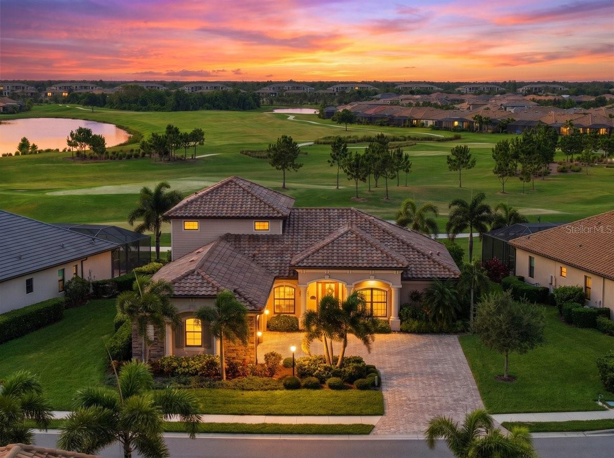 Experience luxury golf course living in this beautifully appointed, MOVE-IN-READY estate home located within the gated resort community of Lakewood National Golf Club. Positioned between the 16th and 17th holes of the Piper Course, this 4-bedroom, 3.5-bath residence with a 3-car garage captures breathtaking southwest-facing sunset golf course views. The fourth bedroom, currently configured as a private study complete with a closet, offers the ideal space for remote work and flexible guest accommodations. Upstairs, the spacious bonus room with full bath, wet bar, wine refrigerator, and golf course views offers exceptional flexibility as a guest retreat or flex space.
Designed to embrace Florida indoor-outdoor living, the expansive lanai showcases a saltwater heated pool and spa, outdoor kitchen, remote-controlled retractable lanai hurricane screen, and a stunning wood-plank ceiling, all surrounded by professionally landscaped grounds and ambient accent lighting. A convenient pool bath enhances the seamless flow for entertaining.
Inside, the open-concept floor plan showcases soaring 10-foot ceilings, hurricane-impact windows, porcelain tile extending through the main living areas, crown molding, plantation shutters, and elegant tray ceilings featured across the home. A dramatic coffered wood-accent ceiling adds warmth and architectural character to the home’s central gathering space.
The gourmet kitchen was designed for both everyday living and entertaining, featuring GE Monogram stainless steel appliances, honed granite countertops, hazelnut soft-close cabinetry, oversized island, pantry, and designer-selected finishes. Nearby, the entertaining bar with dual beverage refrigerators creates the perfect gathering space for hosting family and friends.
The primary suite serves as a private retreat with tranquil golf course views, direct lanai access, spacious walk-in closet, dual vanities, soaking tub, and walk-in shower with rainfall shower system. Additional highlights include luxury vinyl plank flooring in the primary suite and bonus room, custom closet systems in all bedrooms, a beautifully updated guest bath with frameless glass shower enclosure, Florida Blend roof tile, paver driveway, and negotiable furnishings.
As a homeowner in Lakewood National Golf Club, your bundled golf membership includes 36 holes of Arnold Palmer-designed championship golf. Resort-style amenities rival a five-star retreat: a resort pool with zero-entry and cascading waterfalls, poolside Tiki Bar & Café, full-service spa, state-of-the-art fitness center, 8 lighted Har-Tru tennis courts, pickleball, bocce, and a stunning 28,000 sq ft clubhouse with fine dining — all within the security of a 24-hour guard-gated entrance. Located in the award-winning Lakewood Ranch master-planned community, close to A-rated schools, world-class shopping, and Florida's renowned Gulf Coast beaches. This is not just a home — it's a lifestyle. Schedule your private showing today.