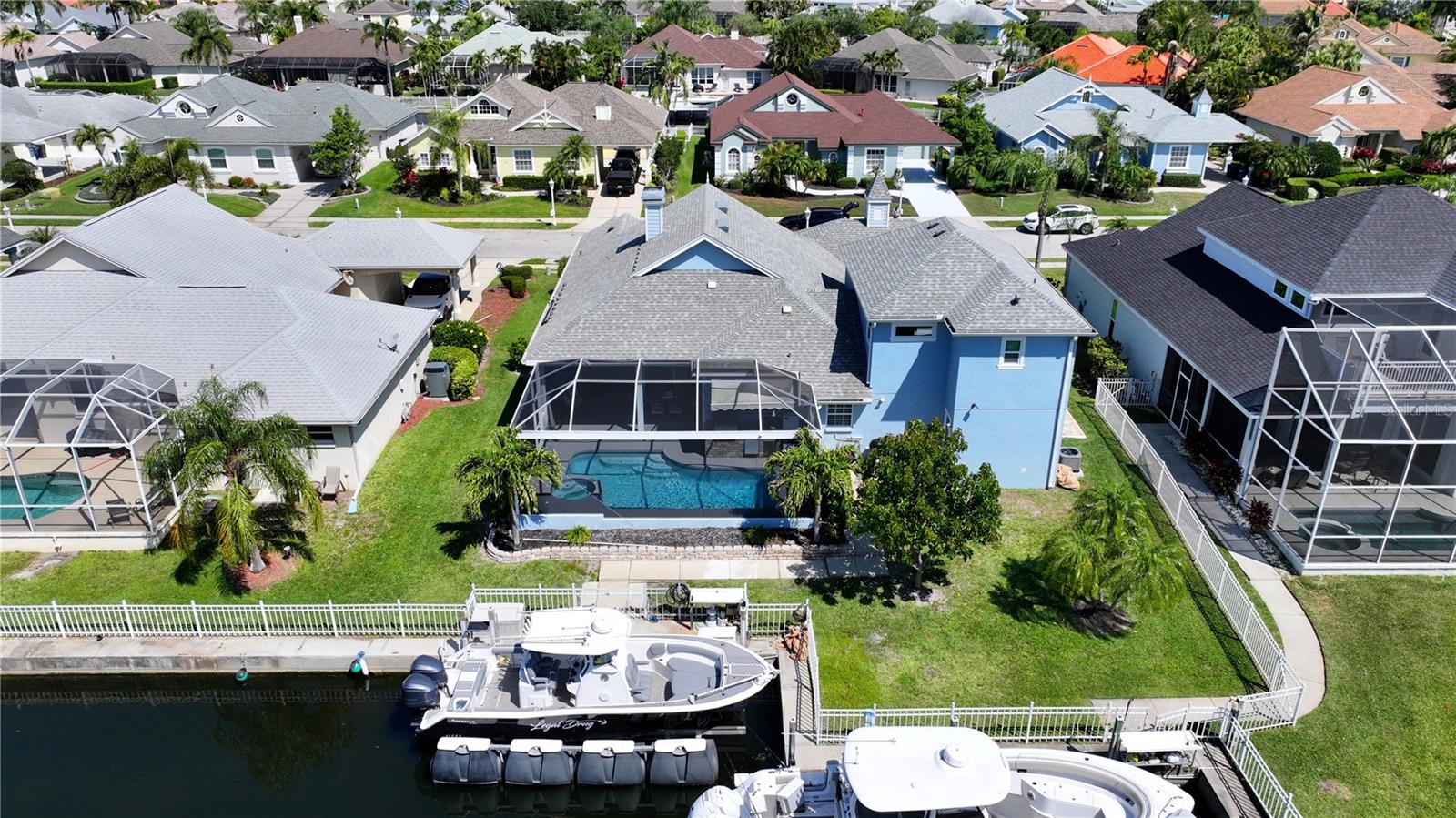 Updated Price! Welcome to an exceptional, one-of-a-kind, expression of Florida waterfront living—where refined design, significant investment, and effortless boating access come together along a private freshwater canal with direct reach to the Manatee River, Tampa Bay, and the Gulf of Mexico. With over **$250,000 in recent upgrades**, this residence offers a true turnkey lifestyle defined by quality craftsmanship, modern convenience, and seamless indoor–outdoor living.

From the moment you enter, the home makes a striking impression. Expansive, light-filled spaces are complemented by soaring ceilings, a natural gas double-sided fireplace, custom shiplap accents, crown molding, and a clean, contemporary aesthetic. The open-concept floor plan has been thoughtfully enhanced to maximize flow and functionality, anchored by all-new luxury vinyl plank flooring throughout the main living areas.

At the center of the home, the fully renovated kitchen delivers both style and performance. Featuring premium quartzite surfaces, upgraded stainless steel appliances, and a well-appointed butler’s pantry, it is equally suited for everyday living and upscale entertaining. The primary suite serves as a private retreat, offering tranquil pool and water views along with a spa-inspired bath designed for comfort and relaxation.

The home’s versatility is further elevated by an approximately 700-square-foot second-floor addition, complete with 2 additional bedrooms, a full bathroom, and generous storage—ideal for guests, multigenerational living, or a private flex space.

Outdoor living is where this property truly excels. A panoramic screened lanai frames the updated saltwater pool, showcasing new tile finishes and fully integrated smart controls. The outdoor kitchen, complete with built-in grill and mini refrigerator, creates an ideal setting for entertaining against the backdrop of peaceful canal views. Additional features including a whole-home gas Generac generator and roll-down hurricane shutters provide both comfort and peace of mind.

For boating enthusiasts, the dock is exceptionally well-equipped with electric, fresh water, a fillet station, and a 10,000 lb HydraHoist boat lift—offering immediate access to open water with ease.

Further enhancing the home’s value and efficiency:

* Two new air conditioning systems (2025)
* On-demand tankless hot water heater
* 220V electric vehicle charging outlet
* Fully integrated smart home system with Google Nest thermostats, bluetooth speakers throughout living area, video doorbell, exterior cameras, and WiFi-enabled pool controls

Beyond the home, the community offers a well-rounded coastal lifestyle with amenities including a kayak launch, scenic mangrove walking trails, playground, tennis courts, and a community boat ramp.

Whether hosting with expansive sliders open to the lanai, enjoying quiet sunset evenings poolside, or heading out for a day on the water, this residence delivers a rare blend of luxury, lifestyle, and location—just minutes from world-class Gulf beaches, UTC shopping and dining, and Sarasota-Bradenton International Airport.