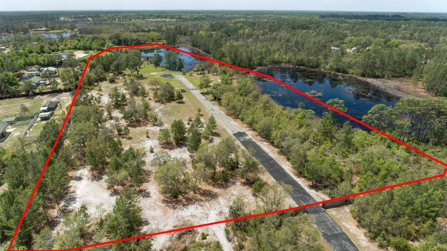 Discover the perfect blend of privacy, nature, and opportunity with this rare 7.26-acre parcel next to the desirable Royal Trails community. This beautiful vacant property features scenic seasonal ponds, water well/pump and small existing structure—offering a great head start for your future homesite, weekend retreat, or recreational escape.
Bordering 20 acres of conservation land and seasonal ponds to the north & west, the property provides exceptional privacy and a peaceful natural backdrop with lots of wildlife & no northern neighbors. Enjoy the freedom of country living with the convenience of being located within Royal Trails—while benefiting from the unique advantage of NOT being in the HOA and being excluded from HOA requirements.
The property is partially fenced on south & east and includes a gated entrance for added security and easy access. With plenty of room for your custom home, workshop, animals, boats, RVs, and outdoor toys, this versatile acreage offers endless possibilities.
Whether you’re looking to build now or invest for the future, this one-of-a-kind property delivers space, privacy, and flexibility in a growing area of Central Florida.