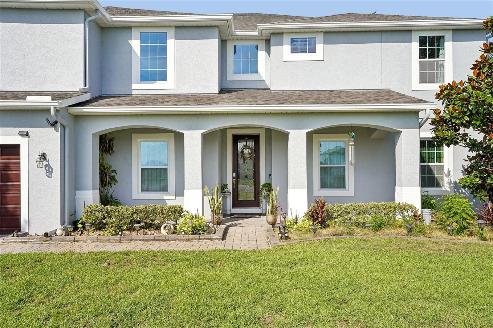 Welcome to this spacious, two-story single-family home in the sought-after Mandalay subdivision. Situated on a generous cul-de-sac lot, this 8-bedroom, 5-bathroom property offers 5,079 square feet of living space. Inside, the open layout shines with a central kitchen featuring granite countertops, dark wood cabinetry, and an island. Floor-to-ceiling sliding glass doors in the main living area offer clear views of the expansive lanai and backyard vegetable garden. The primary suite provides a peaceful retreat with dual walk-in closets, double vanities, a glass-enclosed shower, and a garden tub. Upstairs, a large loft sits adjacent to an office, media room, and a second primary suite. All bedrooms feature walk-in closets, and bathrooms are finished with granite and wood cabinets. Complete with a 3-car garage, solar panels, a well-fed sprinkler system, and easy access to UCF, Waterford Lakes, and downtown Orlando. Come see this exceptional property for yourself. It truly must be experienced in person!