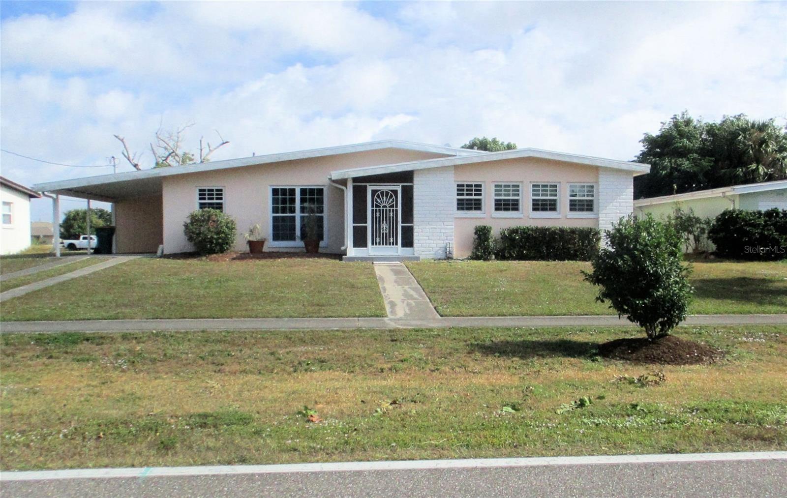 Well-maintained home with view of spring fed freshwater canal with a seawall perfect for fishing. New roof in 2024 with transferable warranty. Home has been re-piped. New carpeting in primary bedroom. Newer hurricane impact windows with privacy windows in each bedroom. Full bath has been remodeled and is wheelchair accessible. Remodeled kitchen has ample cabinet space, granite countertops, a large sink, and a copper vent over range. Freshly painted interior. A/C recently serviced. Home offers larger doorways for handicap accessibility. The 2 bedrooms are large. Laundry room and half bath are accessible from screened lanai. Six ceiling fans – 2 on lanai, 1 in laundry room, each bedroom, and 1 in dining room. Open floor plan with ceramic tile. Screened front porch. All appliances stay. Located close to shopping, dining, medical facilities, beaches, fishing, and boating. Spring training facilities for Tampa Bay Rays and the Atlanta Braves are just minutes away. Access to US 41 and I75 makes traveling to Tampa, St. Petersburg, Sarasota, Punta Gorda, Ft. Myers, and Naples very convenient. Home is not in a flood zone.