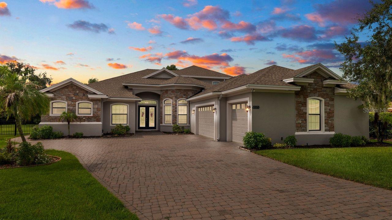 Luxury Citrus Legacy Estate | Exclusive Gated Community Experience the perfect harmony of refined elegance and unparalleled functionality in this magnificent custom estate. Spanning an expansive floor plan, this 5-bedroom, 4.5-bathroom with a huge flex room residence is a masterpiece of design. Located in the heart of Lakeland, Florida, this home sits on land once defined by the region's legendary citrus heritage. Now, it stands as the centerpiece of an ultra-exclusive, gated enclave of only ten residences, offering the ultimate in privacy and prestige. The Ultimate Indoor-Outdoor Lifestyle This home is a true entertainer's dream, anchored by a massive, professionally designed lanai that perfectly captures the Florida lifestyle. The outdoor living space features a complete outdoor kitchen equipped with a premium built-in gas grill, creating the perfect setting for seamless year-round hosting. Beyond the kitchen, indulge in your own private resort with a sparkling saltwater pool and spa. Gourmet Culinary Sanctuary At the heart of the home lies a professional grade gourmet kitchen, designed for the serious chef. Featuring high-end appliances, custom cabinetry, and a suite of ''whole gas'' features--including a high-performance gas stove--this space is as functional as it is beautiful. Premium Gas & Smart Infrastructure Built for those who value efficiency and peace of mind, this home features: A whole-house generator provides complete reliability, while three dedicated HVAC units give precision zoned climate control. Gas-Powered Luxury: A ''whole gas'' residence featuring a tankless water heater for endless hot water, a gas stove, and a dedicated gas hook-up for the laundry suite. Architectural Grandeur: Impressive, soaring front entry doors and expansive sliding glass walls that create a seamless, light-filled flow between the great room and the sprawling outdoor space. Garage & Storage: A massive, oversized garage designed to accommodate large vehicles, storage, and projects with ease. Prime Lakeland Living Positioned minutes from the area's finest attractions, you are never far from the action. Enjoy quick access to the vibrant culture of Florida Southern College, entertainment at the RP Funding Center, and spring training at Joker Marchant Stadium. For nature lovers, the serene trails of Circle B Bar Reserve and the iconic Bok Tower Gardens are just a short drive away. Discover the lifestyle you deserve. This rare property represents the absolute best of Lakeland living. Schedule your private tour today to experience the grand scale and exquisite craftsmanship of this estate in person.
https://youtu.be/dhooN__LpzM?si=m_l1f-f0FUZWi8SS