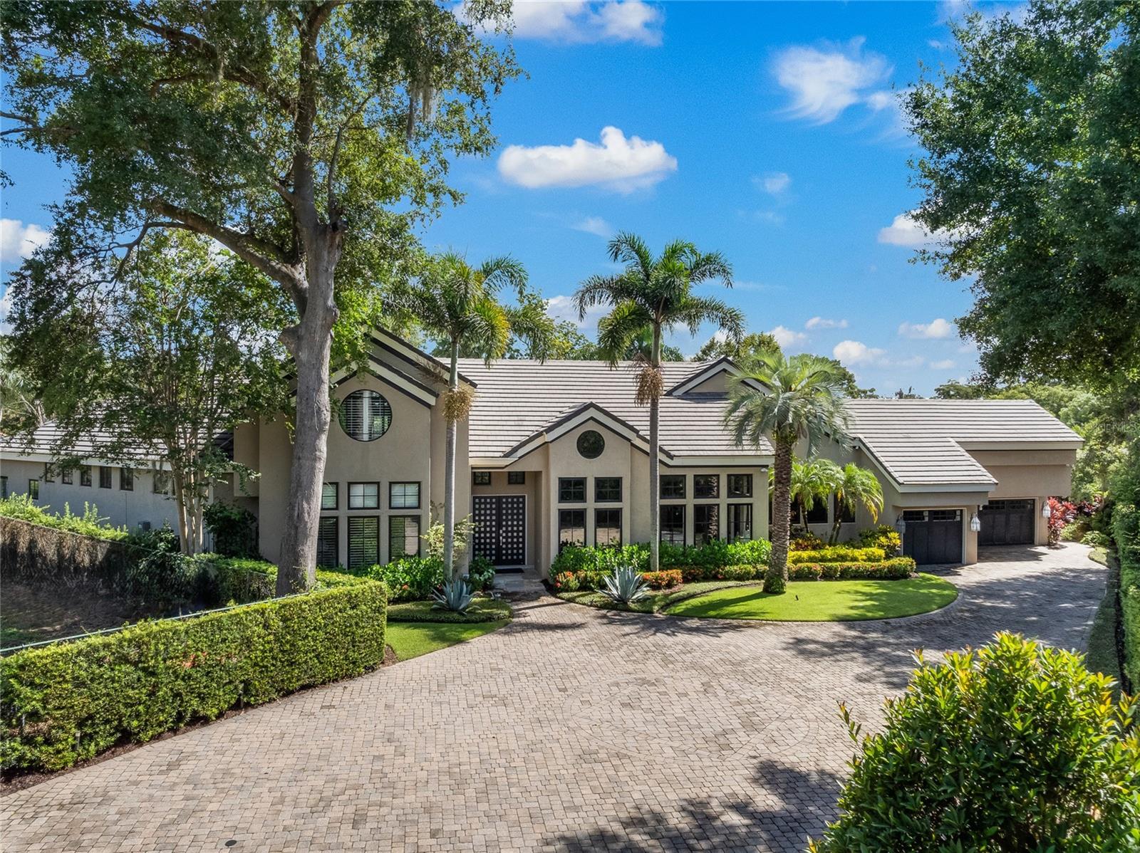 Welcome to an exquisite 3-bedroom, 5.5-bath plus office pool home in the heart of Winter Park. Set back 150 feet from the picturesque brick street, this stunning residence offers unparalleled privacy and elegance, exuding sophistication from the moment you arrive. Stately double-front doors open into a grand foyer with direct views of the beautiful pool and meticulously landscaped backyard. Step inside to discover a magnificent custom concrete and iron staircase that sets the tone for the remarkable craftsmanship throughout the home. The spacious open kitchen overlooks the family room and breakfast area, providing seamless access to the covered lanai. Outfitted with sleek European custom cabinetry by NEFF, double islands, two dishwashers, and top-of-the-line Wolf/Subzero/Miele appliances, the kitchen is a chef’s dream with ample storage for all your needs. The inviting family room features a stunning gas fireplace, coffered ceilings, and a large custom bar complete with a wine refrigerator. Designed for grand entertaining, the home offers large-scale rooms with soaring ceilings that create an open and airy ambiance. The formal living and dining areas are enhanced by large picture windows that bathe the rooms in natural light, offering picturesque views of the sprawling grounds. The outdoor living space is nothing short of extraordinary, featuring a cozy outdoor living room with a gorgeous gas fireplace, a dining area, and a built-in grill. Motorized screens open to reveal the pool and manicured backyard, creating an idyllic setting for relaxation and entertainment. The primary suite on the first floor is a sanctuary of luxury, offering two separate baths, each with its walk-in closet and access to the pool area. An elegant office or optional fourth bedroom and a secondary bedroom with an en-suite bath are also on the first floor. Upstairs, you'll find a secondary primary suite with a spacious en-suite bath, featuring dual vanities, a luxurious spa-like soaking tub, and a glass-enclosed shower. For added convenience, there’s an upstairs wet bar perfect for refreshments, alongside ample cabinetry providing extra storage and space for hanging clothes. Additional features include a full-house generator, well irrigation system, a five-zone A/C system for optimal climate control, and a three-car attached garage with a brick paver-gated driveway leading to a motor court, ensuring ample parking and privacy. This truly unique property has been done and maintained to the highest standards, offering an unparalleled lifestyle. Situated in a top-notch location, just a short distance from vibrant shopping and restaurants on Park Avenue and the iconic Winter Park Golf Course, this home is a rare opportunity to experience the epitome of luxury living in Winter Park.