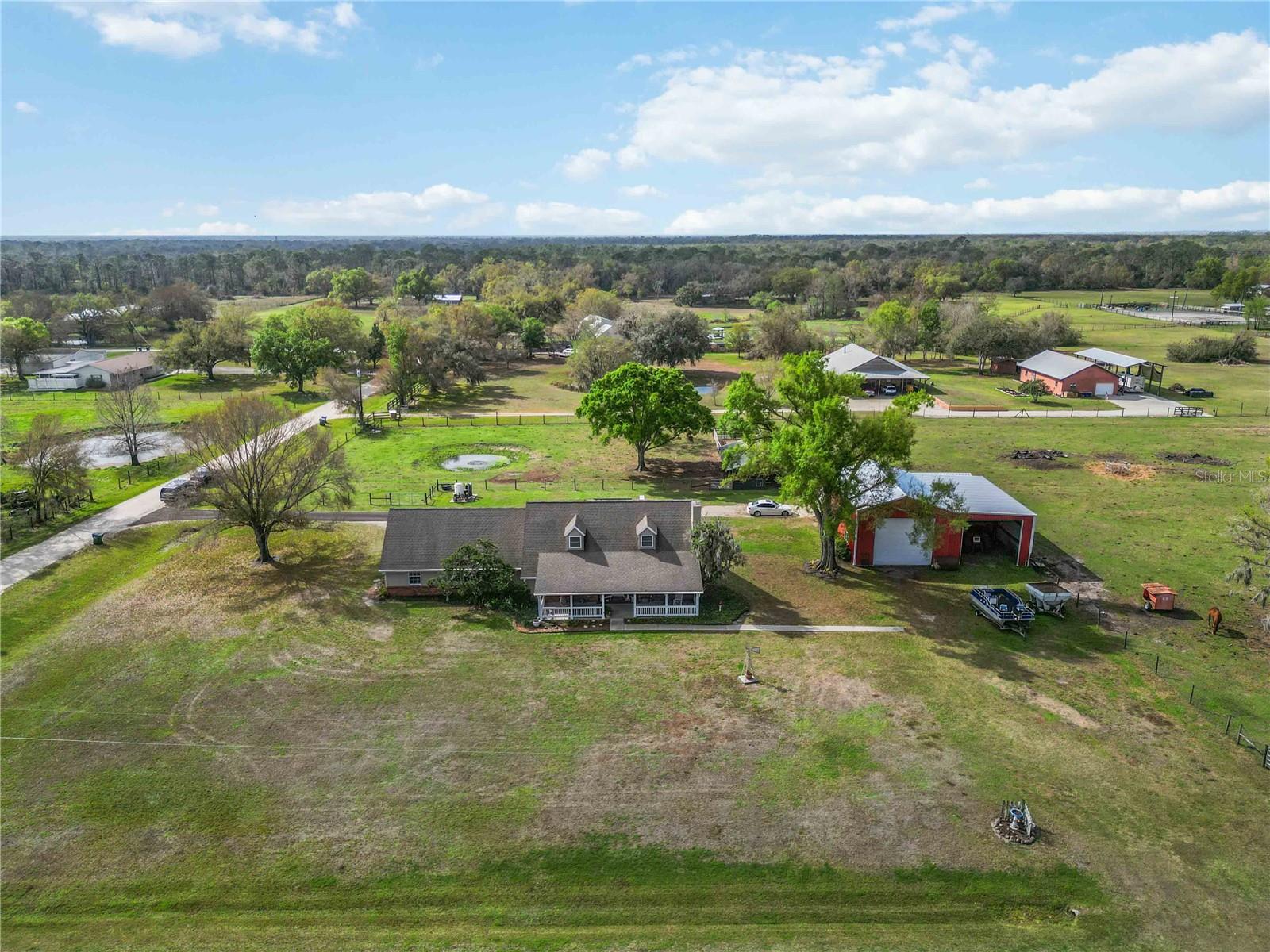 Situated on 5 beautiful acres, this versatile Sarasota property offers the perfect combination of space, functionality, and country living while still being conveniently located. The property features a large barn/warehouse with soaring ceilings, easily accommodating RV parking and equipped with a car lift, making it ideal for hobbyists, car enthusiasts, contractors, or anyone needing significant workspace or storage.

In addition to the main home, the property includes a separate 1-bedroom in-law suite complete with a full kitchen, bathroom, living room, and its own laundry, providing excellent flexibility for guests, extended family, or potential rental income.

The main home is thoughtfully designed with the primary suite located on the ground floor, while additional bedrooms and a spacious upstairs playroom provide plenty of room for family and guests. The property is partially fenced and currently home to horses and cattle, and also includes a horse stall, making it well suited for equestrian or agricultural use.

Additional features include a well system and owned solar panels, helping keep monthly utility costs low.

With acreage, usable outbuildings, and a flexible layout, this property offers a rare opportunity to enjoy privacy, space, and functionality in Sarasota.
