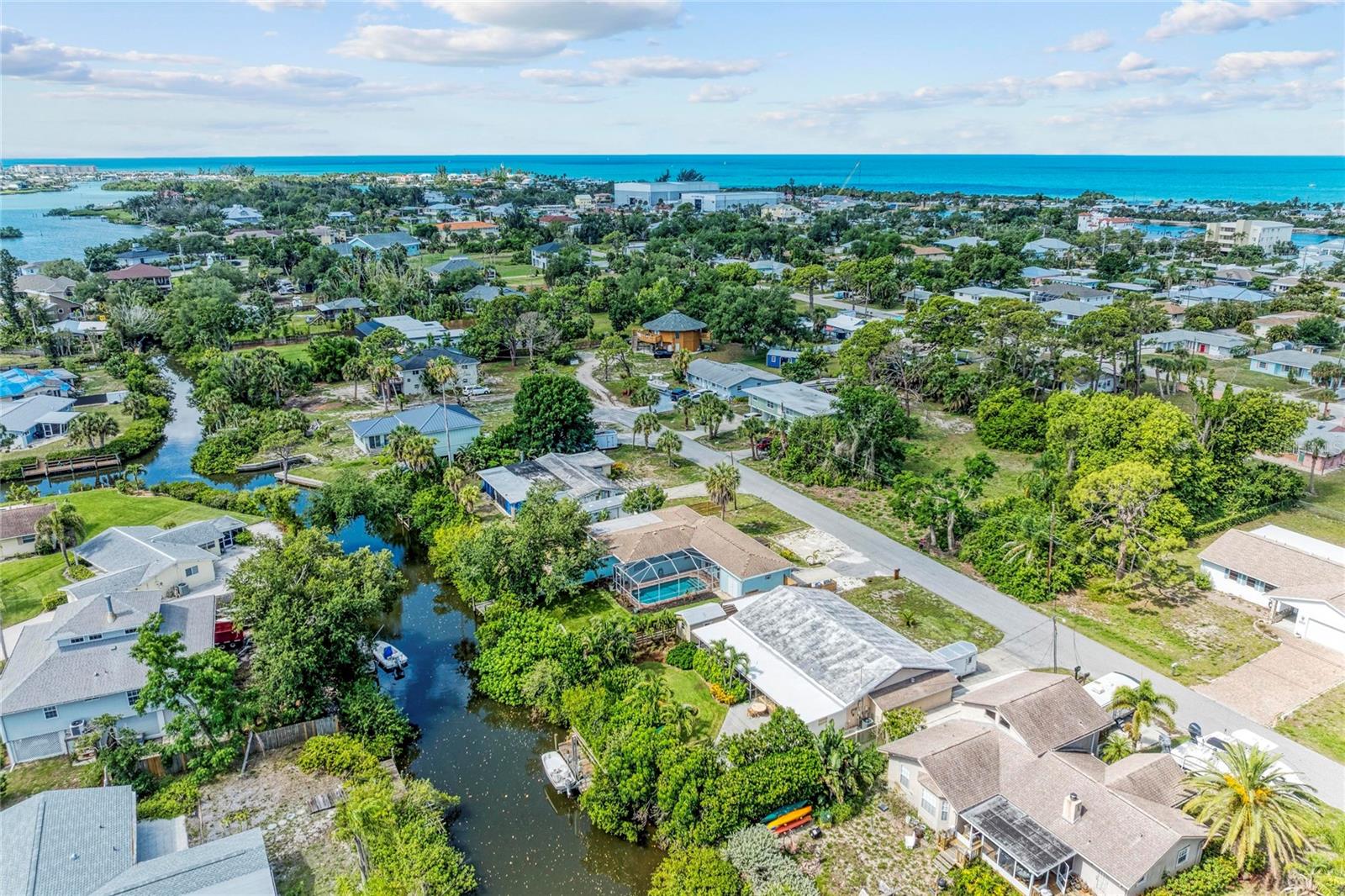 Tucked away in the hidden waterfront community of Channel Acres, this canal-front pool home captures the kind of Old Florida lifestyle that buyers spend years searching for with boating, beach days, tropical privacy, and laid-back coastal living just minutes from Nokomis Beach and the Intracoastal Waterway. Set on an oversized canal-front lot with a private dock, screened pool, and direct access out to the Gulf, this property offers a rare opportunity to own waterfront in one of Southwest Florida’s most beloved beach communities, without the multimillion-dollar price tag often attached to the lifestyle. Inside, the home offers approximately 1,746 square feet with 3 bedrooms, 1.5 baths, flexible living spaces, and a bright coastal feel ready to be personalized over time. Whether you envision a relaxed beach bungalow, seasonal retreat, vacation rental, or a long-term waterfront escape, the setting here is what truly makes this property special. Spend mornings boating through the bay, afternoons at Nokomis Beach, and evenings cruising by golf cart to waterfront restaurants, live music, and sunset dinners at local favorites nearby. The backyard feels like a private tropical retreat with mature landscaping, canal views, a screened pool, and space to create your own outdoor paradise. Recent improvements include a newer roof and updated dock, giving buyers a strong foundation while leaving room to modernize and add value over time. Properties like this are becoming increasingly difficult to find offering canal frontage, boating access, pool, dock, oversized lot, and proximity to the beach all in one location. For buyers chasing the authentic Florida waterfront lifestyle, 312 Winfield Way is the opportunity to make it your own.