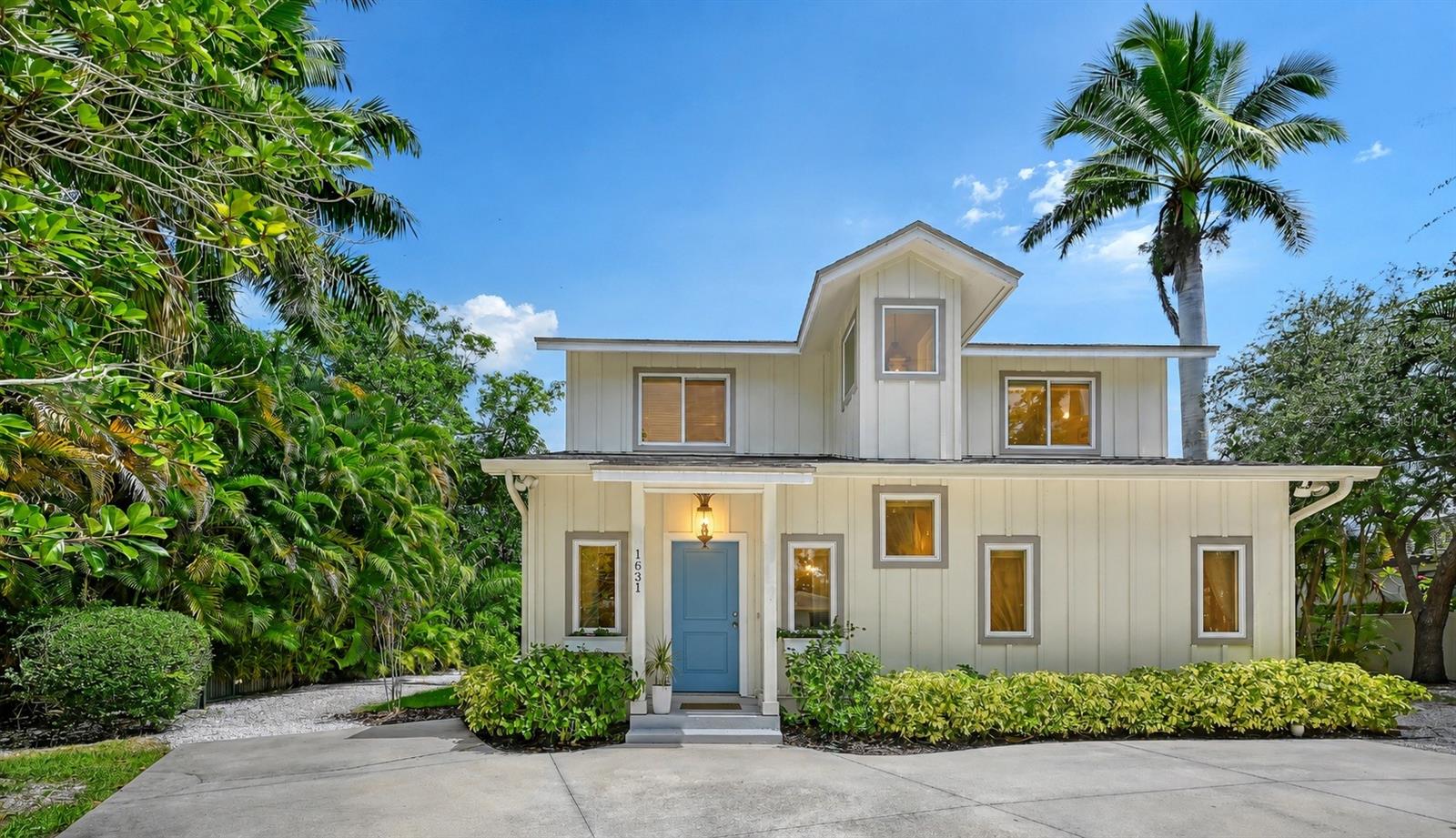 Beautifully maintained and ideally located West of Trail on a quiet dead-end street, this 2015-built residence offers the perfect blend of timeless coastal style, modern comfort, and an unbeatable Sarasota location. Featuring 3 bedrooms, 2.5 baths, and a thoughtfully designed floor plan, the home lives beautifully for both everyday living and effortless entertaining.  A welcoming front porch and lush tropical landscaping create exceptional curb appeal, while inside, abundant natural light, engineered hardwood flooring, soft neutral finishes, and quality craftsmanship establish a warm, inviting atmosphere. The open-concept living area is anchored by a custom built-in entertainment center with an electric fireplace, creating a stylish focal point for gathering with family and friends. The beautifully appointed kitchen features shaker-style cabinetry, stainless steel appliances, under-cabinet lighting, pendant lighting, and a generous breakfast bar that seamlessly connects to the living and dining areas. French doors open to the screened lanai, creating an effortless transition between indoor and outdoor living. The first-floor primary suite offers privacy and convenience with hardwood flooring, generous natural light, a walk-in closet, and an updated en-suite bath featuring a glass-enclosed shower with timeless subway tile finishes. Upstairs, two spacious guest bedrooms and a full bath provide comfortable accommodations for family and guests. Outdoor living is equally impressive. The screened lanai overlooks an expansive, partially fenced backyard framed by mature tropical landscaping and privacy hedges, offering ample space for entertaining, gardening, pets, or the future addition of a pool. Ideally situated just minutes from Downtown Sarasota, Southside Village, Sarasota Memorial Hospital, Selby Gardens, and the area's world-renowned beaches, this move-in ready home presents an exceptional opportunity to enjoy one of Sarasota's most sought-after West of Trail neighborhoods with outstanding access to dining, shopping, arts, and waterfront recreation.