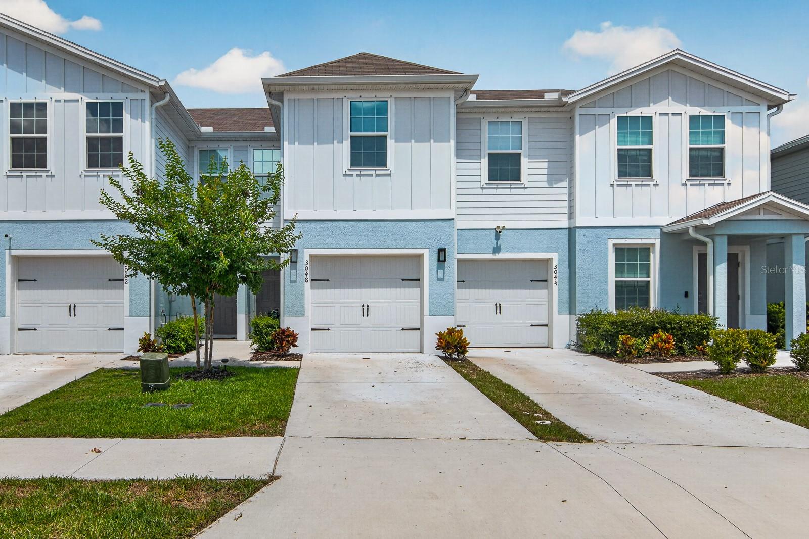 One or more photo(s) has been virtually staged. Forget the endless weekend honey-do lists and the hidden costs of an older home. Built in 2023, this 3-bedroom townhome gives you that clean, brand-new feel without the builder’s waitlist. The main floor is wide open, flowing from the living room right into a kitchen that actually has room to move. The owners upgraded the kitchen past the builder-grade standard by adding a custom tile backsplash that pairs with the neutral white quartz counters and breakfast bar. Just past the living area, you can step out onto your enclosed patio space—perfect for morning coffee or unwinding in the evening with the rare perk of having zero backyard neighbors directly behind you. Upstairs keeps life practical: the primary suite features its own private bath, while the other two bedrooms work perfectly for guests, roommates, or a dedicated home office. Plus, the laundry closet is upstairs right where the clothes actually are. Your monthly overhead is incredibly lean here. There is NO CDD fee, and the low HOA covers your exterior maintenance, high-speed internet, and cable TV package right out of the gate. Metal storm shutters and a 1-car garage are already checked off the list for you. Location-wise, you are right in the sweet spot for everyday convenience and weekend fun. For daily needs, you’re just minutes from major grocery chains, retail shopping, medical facilities, and US-19 for an easy commute. When you want to head out, you're a stone's throw from the Pinellas County line, putting the historic Tarpon Springs Sponge Docks, Anclote River Park boat launches, coastal trails, and local waterfront dining practically in your backyard. Clean, modern, private, and zero yard work to eat up your weekends.