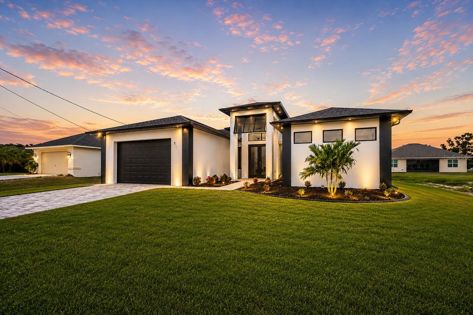 Virtually Staged. This elegant and modern 2024 built pool home is designed to impress. Featuring 3 bedrooms, 2 full bathrooms, and a 2-car garage, the home offers approximately 2,000 sq. ft. of beautifully designed living space. Step outside to a spacious enclosed lanai with a large pool, oversized lounge area for soaking up the Florida sunshine, and a built-in outdoor grill station complete with a wine cooler—perfect for entertaining or relaxing at home. Enjoy beautiful sunrises every morning with Eastern exposure. The large outdoor seating area overlooks dual glass sliding doors that open into the living and dining spaces, creating a seamless indoor-outdoor flow. 

Inside, the living room showcases a custom built-in TV feature wall with a 65” TV and electric fireplace. There are 10 ft coffered ceilings in the living area and 14 ft entryway ceilings. Natural light reflects off the stunning porcelain tile flooring that runs throughout the entire home, enhancing the open and airy feel. The kitchen is thoughtfully designed with quartz countertops, stainless steel appliances, elegant cabinetry, and generous storage. A large waterfall island with additional seating anchors the space and overlooks the dining and living areas, making it ideal for both everyday living and hosting guests. The owner’s suite offers private lanai access through its own sliding door, two walk-in closets with built in shelving, dual vanities, and a large beautifully designed spa-style bathroom with a spacious shower and soaking tub. Additional highlights include hurricane impact windows and doors, along with many other quality features throughout the home that must be seen in person to be appreciated. Conveniently located just a short drive, or walk to Coral Shores Plaza, nearby parks, Matlacha Isles and the upcoming 7 Island Project—this home delivers both luxury and lifestyle. City Water and Sewer and no HOA’s!