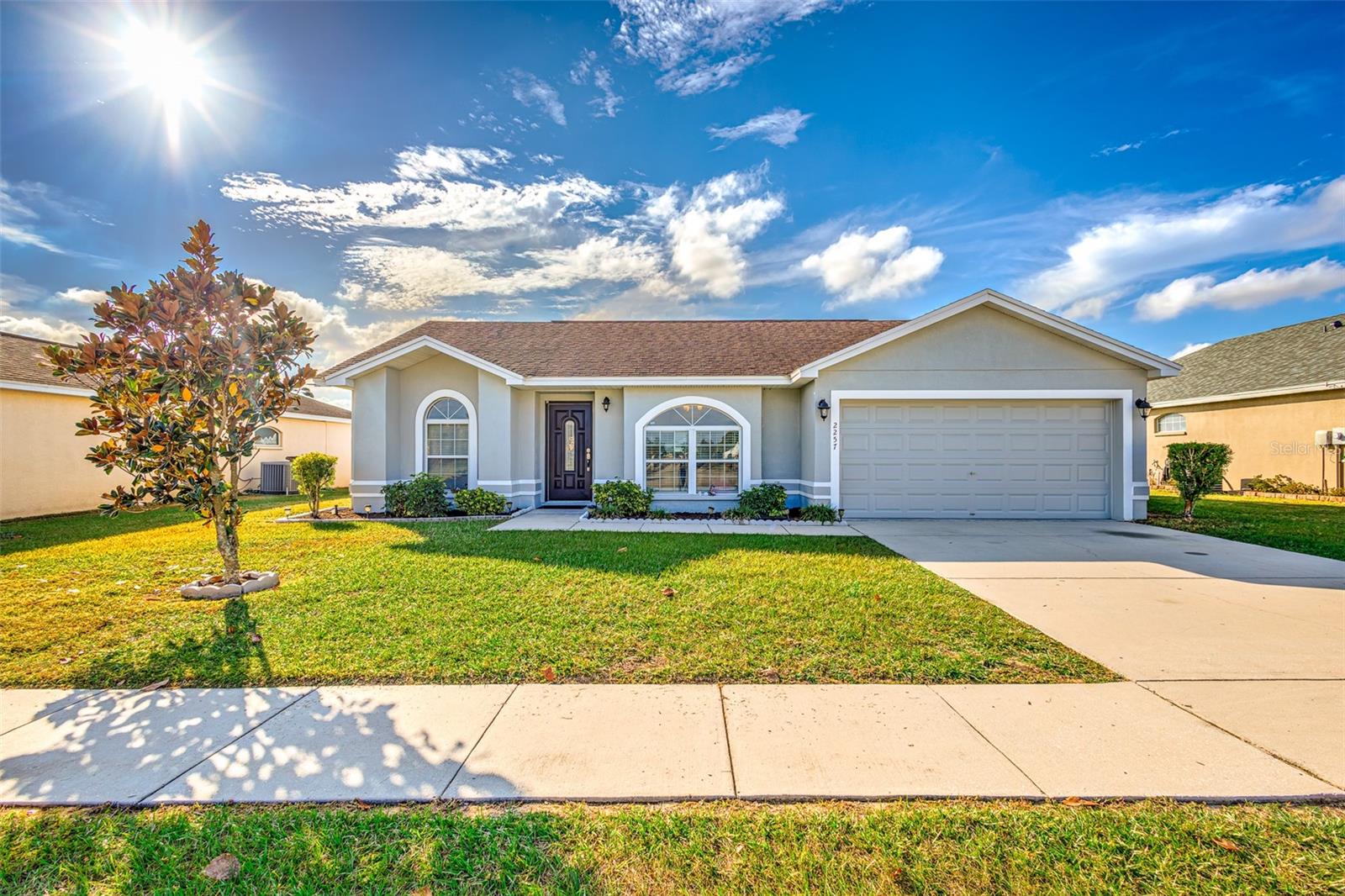 Move-In Ready 3 bedroom / 2 bath Split plan home conveniently located between South Lakeland and Historic Bartow. Minutes to the Polk Parkway, 540-A and HWY 98 South. Light and airy open floor plan with sprawling Vaulted ceilings throughout! The Master bedroom offers ample floor space, Vaulted Ceilings, an on-suite bathroom along with a walk-in closet. On the other side of the home, you will find two bedrooms and a full hallway bathroom. The eat in kitchen complete with recessed lighting is warm and inviting, and located right off the garage for easy access to bring in the groceries!  The screened lanai is perfect for grilling while enjoying the fully fenced spacious backyard***features and upgrades*** Exterior & Interior paint (2022), Luxury Vinyl Plank Flooring (2022) roof (2015), kitchen appliances are in good working condition, The AC is serviced annually. Fully Fenced Backyard. Established neighborhood with a Low HOA. Beautiful Playground just across the street. This desirable home is just minutes to Spessard Holland elementary, Shopping and plenty of restaurants. Whether you are a first time Buyer or looking  for a winter residence this is THE place to call home. Call today to schedule your private showing.