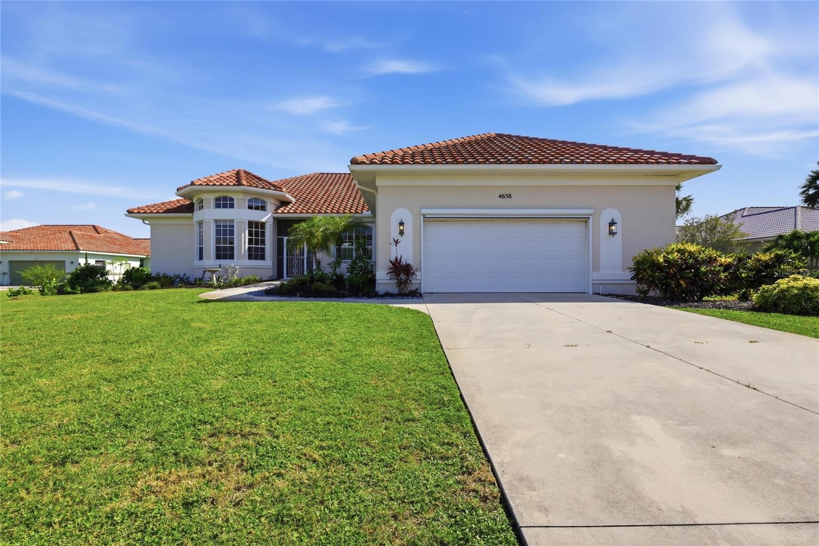 Virtually Staged. Waterfront living at its finest on beautiful Amberjack Creek! This beautifully remodeled 3-bedroom, 2.5-bath home is situated on an oversized waterfront lot and offers the perfect blend of comfort, space, and Florida lifestyle. Featuring a spacious split-bedroom floor plan with both a great room and separate family room, this home is designed for relaxing and entertaining alike. Terracotta tile flows throughout the living areas, while the newer open kitchen boasts an island, abundant cabinet space, a wine refrigerator, and seamless access to the living and dining spaces.
The den/office offers flexibility and could easily serve as a fourth bedroom. Triple sliding glass doors open to the oversized screened lanai with a sparkling pool, creating an ideal indoor-outdoor living experience. Enjoy waterfront views and easy boating access from the wood dock complete with power and water. Additional highlights include a sprinkler system, oversized 2-car garage with workbench, newer A/C, and plenty of storage throughout. House elevation is  11 feet. Listing is selling turnkey. 
 This exceptional waterfront property is ready to enjoy!