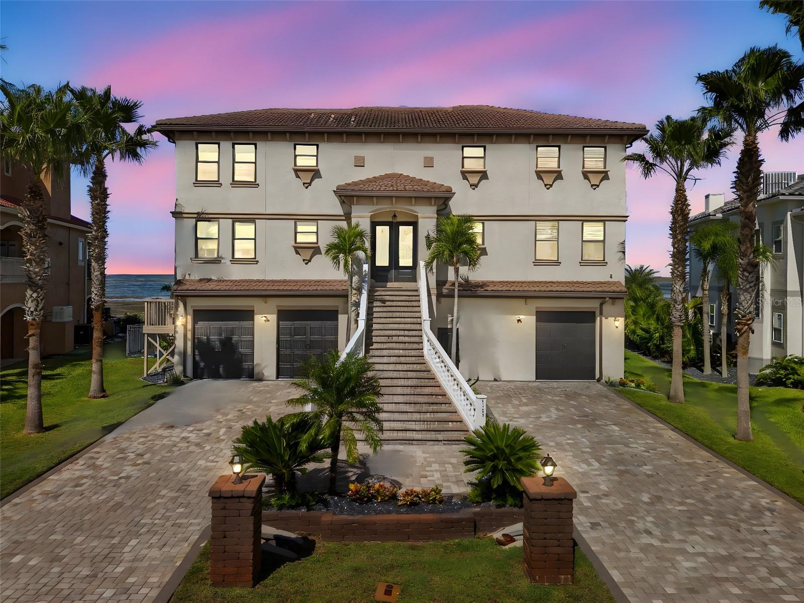 One or more photo(s) has been virtually staged. Commanding 100+ feet of direct Gulf frontage, this Mediterranean masterpiece is a rare Gulf-to-Intracoastal estate that epitomizes timeless coastal elegance. Set within the exclusive gated enclave of Harborpointe in Pasco County Florida, where the legendary stilt houses rise like proud sentinels in the distance of your backyard—this residence was crafted for those who want to call a location home.

Ready, Set, Go! Spanning generous living space across multiple levels served by a private elevator adjacent to the front door upon entry, the home offers 4 bedrooms, 3 full and 1 half baths, plus a wealth of opulent living areas designed to flow like the tide itself. Wide-plank hardwood floors stretch beneath soaring ceilings, while an open floor plan seamlessly connects formal dining, a serene study, and grand living spaces bathed in natural light.

A chef’s playground awaits in the custom gourmet kitchen, featuring stainless-steel professional appliances, expansive island seating, and a breakfast nook kissed by breathtaking Gulf-front views. Step outside to nearly 1,000 square feet of oceanfront porches and covered terraces that frame a private resort backyard: saltwater pool, elevated spa, summer kitchen with bar, and a firepit perfect for sunset gatherings. The primary suite is built for royalty—spacious and serene, with direct Gulf views, a luxurious bath, and private access to the expansive porches. Three additional bedroom suites ensure comfort and privacy for family and guests.

Additional highlights include a deeded boat slip directly across the street at Harborpointes' exclusive resident-only marina, offering effortless access to the open Gulf and Intracoastal waters. Deepwater dock potential, newly renovated deck off the kitchen with luxurious travertine throughout. Just moments away from downtown New Port Richey, and vibrant city life, this Harborpointe masterpiece defines the pinnacle of Gulf-front luxury living.