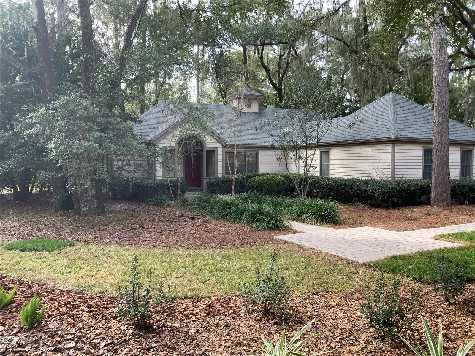 Charming Cape Cod Style home on corner lot in Laurel Park. Fully renovated and move-in ready; freshly painted with new luxury vinyl plank flooring and new carpet in all bedrooms. Architectural roof (2012), new HVAC (2023), new gas Hot water heater (2023). Welcoming paver walkway with slate entrance portico. Great room with high ceilings features a brick wood-burning fireplace and French doors opening onto wood deck. Kitchen features tiled counters, newer Whirlpool Stainless appliances, new sink & fixtures, and pass through to the living room. Bonus office/utility room with built-in wood cabinets and shelfs. Whirlpool washer & dryer in Garage, Split plan with spacious owner's suite with door opening onto deck. Renovated owners' bath with walk in shower, new sink, toilet and fixtures. Spacious 2 car garage. Large deck off back porch features covered enclosed gazebo. Newly landscaped yard and private back yard with green space. Walking distance to Haile Village Center, Saturday farmers market, and walking paths and trails.