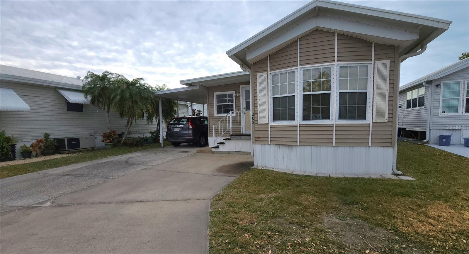 OFFERS WELCOME AS SELLER NEEDS IT SOLD! TWO BEDROOM, 1 1/2 BATHROOM MOBILE HOME IN ACTIVE 55+ COMMUNITY. This 800 Square ft., furnished home is just waiting for you to make it your own. A/C replaced in 2022, Single Carport, Metal Roofover. Spacious living and dining rooms. Second bedroom has an en suite half bath. The laundry room is large enough for extra guest sleeping options.   SUGAR CREEK COUNTRY CLUB CO-OP HAS LOW HOA FEES of just $600 quarterly which includes water, trash, sewer, basic cable, internet, and grass mowing. There are two swimming pools, heated spa, clubhouse, tennis, pickleball, shuffleboard, a fitness room, and workshop. There is an active social calendar with fun activities and outings during the winter months. Enjoy this community's proximity to the Braden River and River Links Golf Course. Sorry this is not a dog lot.