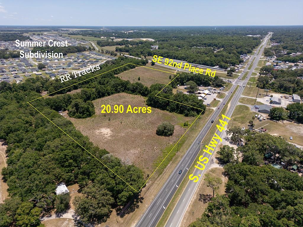 Commercial District- 21.16 acres, high, dry and flat with all-important electric, water and sewer utilities accessible. 800' of prominent highway frontage on HWY 441 at the SE 92 Loop. The new "Commercial District" offers unmatched flexibility for the widest range of commercial uses - B5 zoning includes all uses from B1-5. Up and coming “Belleview, the City in the Center,” is a short commute to Ocala, Silver Springs, Summerfield, The Villages, Ocala National Forest and I-75 and has a drastic shortage of popular commercial projects to support its rapidly growing workforce population. This high traffic large parcel provides exceptional versatility, visibility and accessibility, making it an ideal location for retail, medical, business, hospitality, or multi-use projects to serve the current proliferation of workforce and retiree migration to the fastest growing area in Florida.
